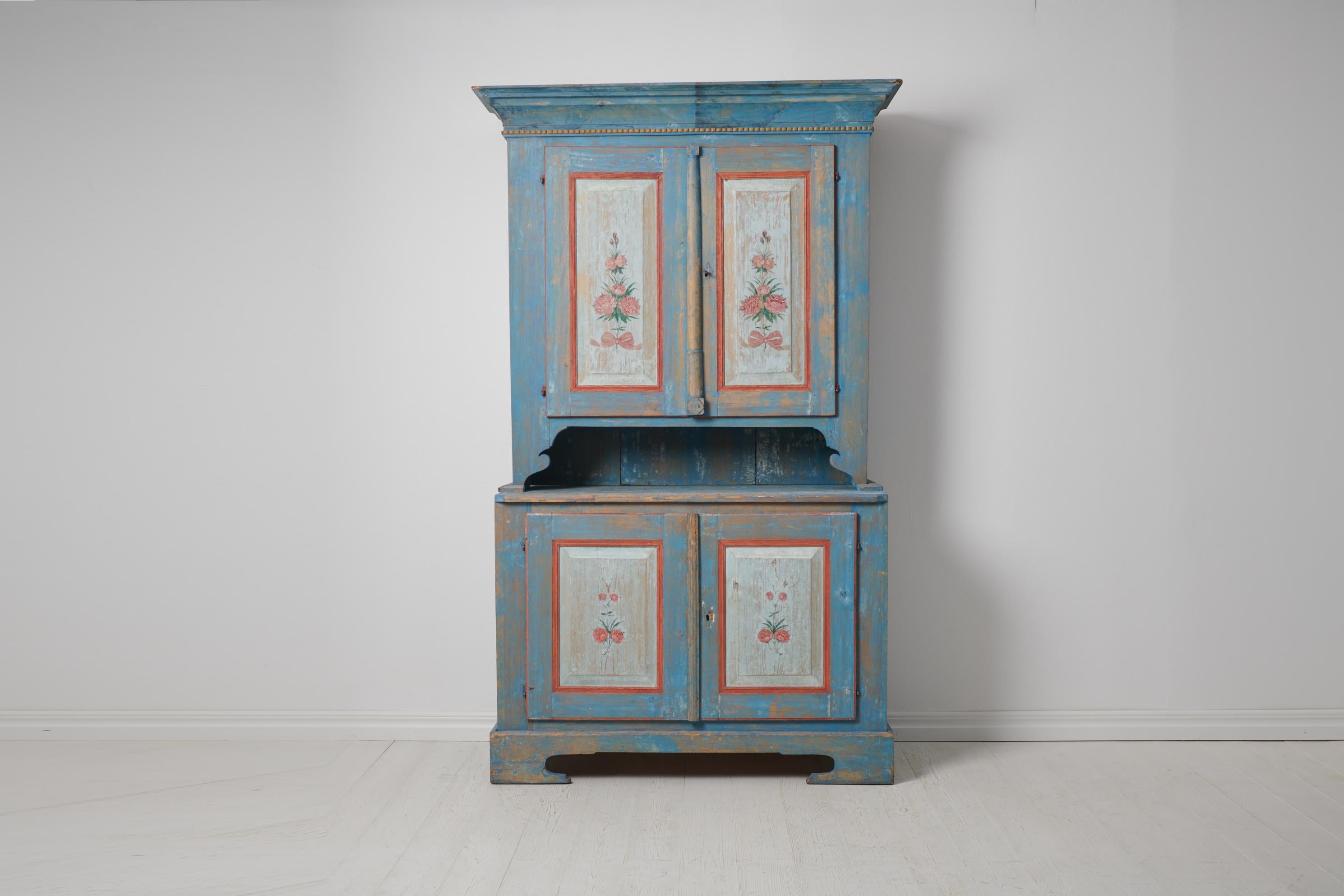 Antique Swedish blue cabinet. The cabinet is a genuine Swedish country house furniture from the early 1800s, around 1820. The cabinet is in two parts and made by hand from solid pine. The paint is original with authentic distress and patina of time.