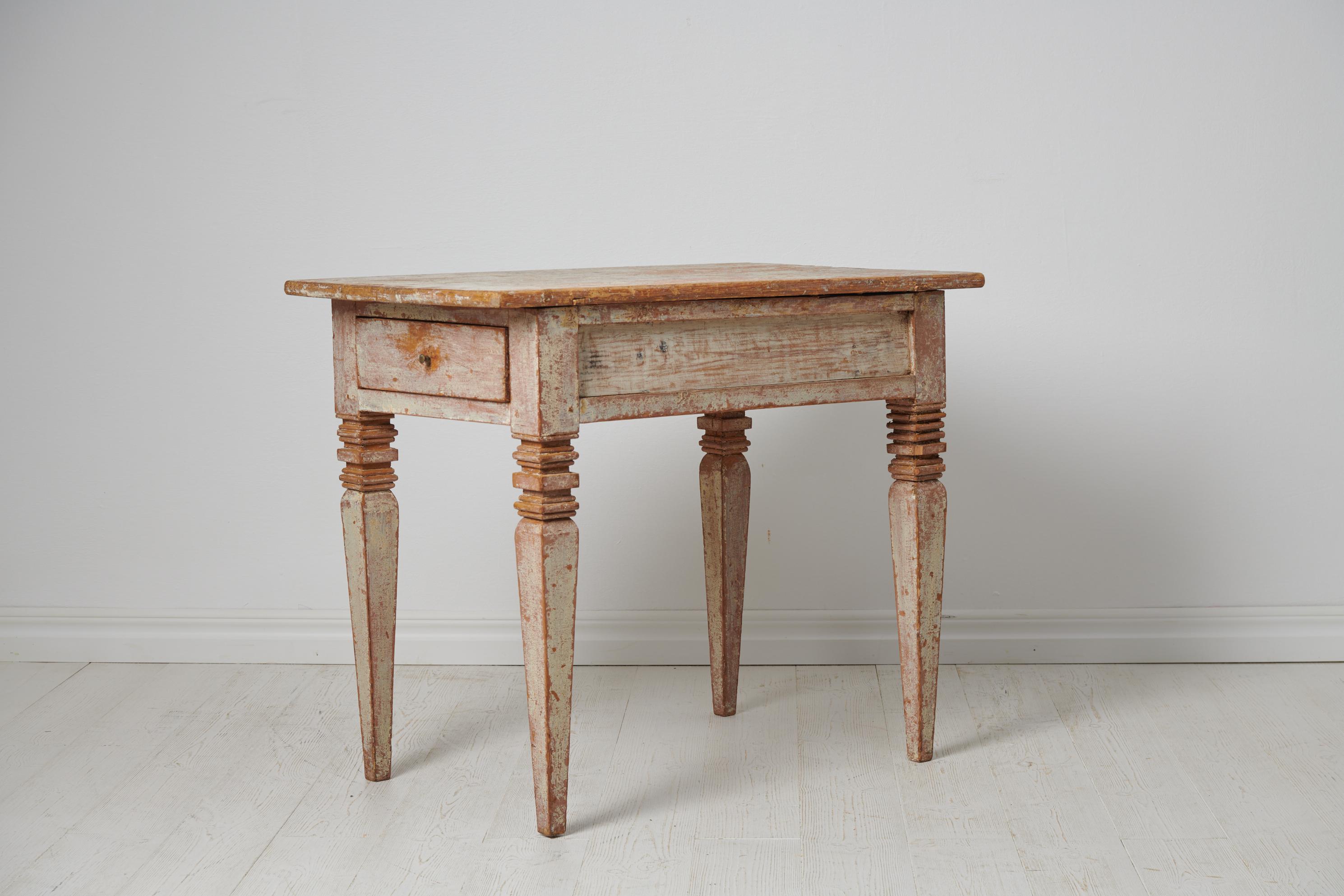 Antique Swedish gustavian table from around 1810. The table is gustavian, also known as neoclassic, and made in solid Swedish pine. The table has the original paint with a rustic character with genuine patina and distress after 200 years of use. It