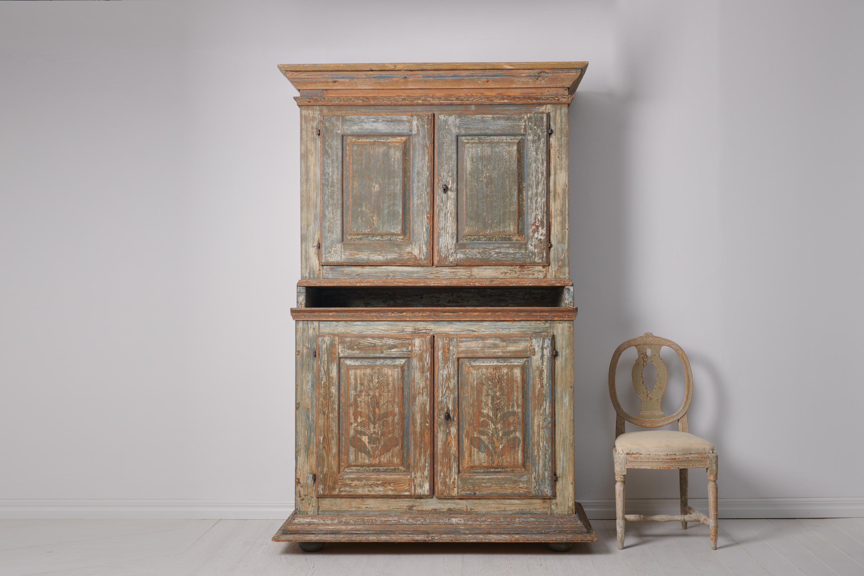 Antique Swedish baroque cabinet. The cabinet is a genuine Swedish country house furniture from the late 1700s. It is a proper statement piece made by hand in solid pine. The cabinet is painted and has the original paint which has become worn and