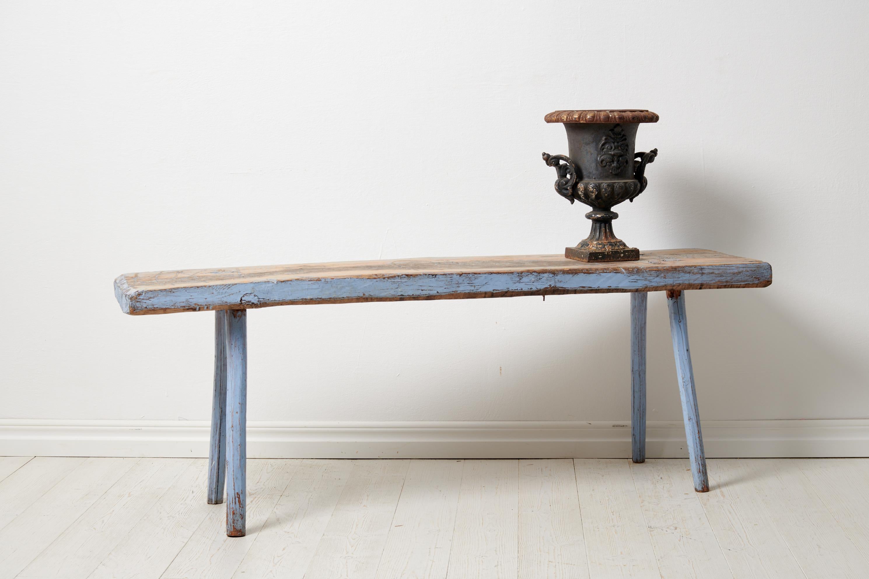 Primitive antique country bench from Sweden. The bench is a genuine country house furniture made by hand in solid pine. The bench has old historic paint which has become distressed with time making the unique patina it has today. There are also