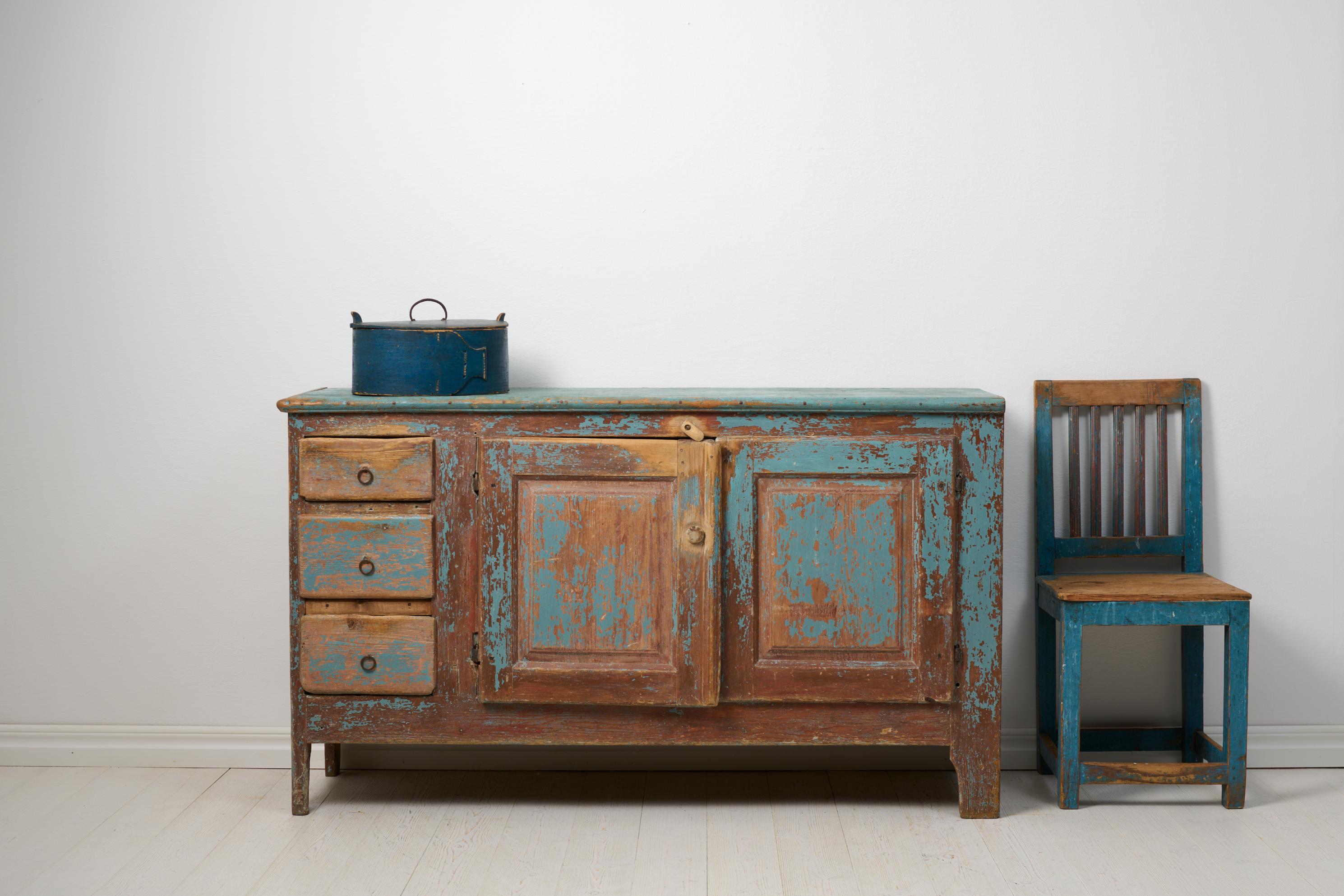 Antique rustic low sideboard from the early 1800s, around 1820 to 1840. Step back in time with this captivating antique rustic low sideboard, a true gem from the early 1800s. A genuine Swedish country house masterpiece, this handcrafted solid pine