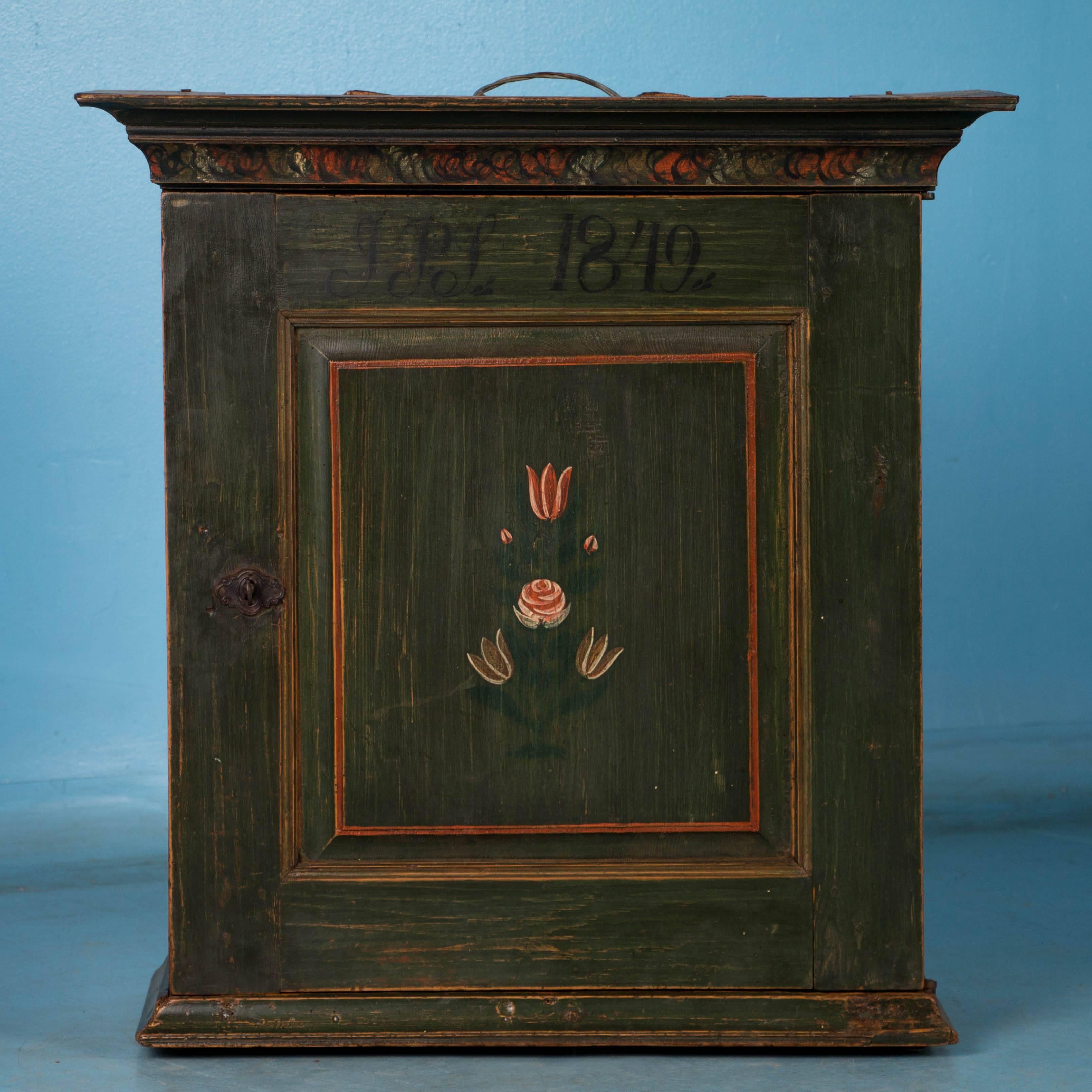 The surprise is inside this unique Swedish Folk Art painted wall cabinet dated 1849. The same lightly distressed green paint on the outside is found inside as well, with multiple drawers and cubbies for all kinds of storage. Please take a moment to