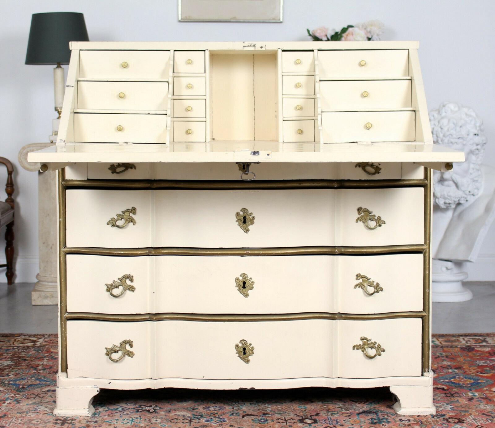 Large 19th century Swedish painted and carved bureau in the Gustavian manner.

The carved fall flap enclosed a fitted interior comprising four columns of miniature drawers and storage. Fitted four graduated serpentine front long drawers below with