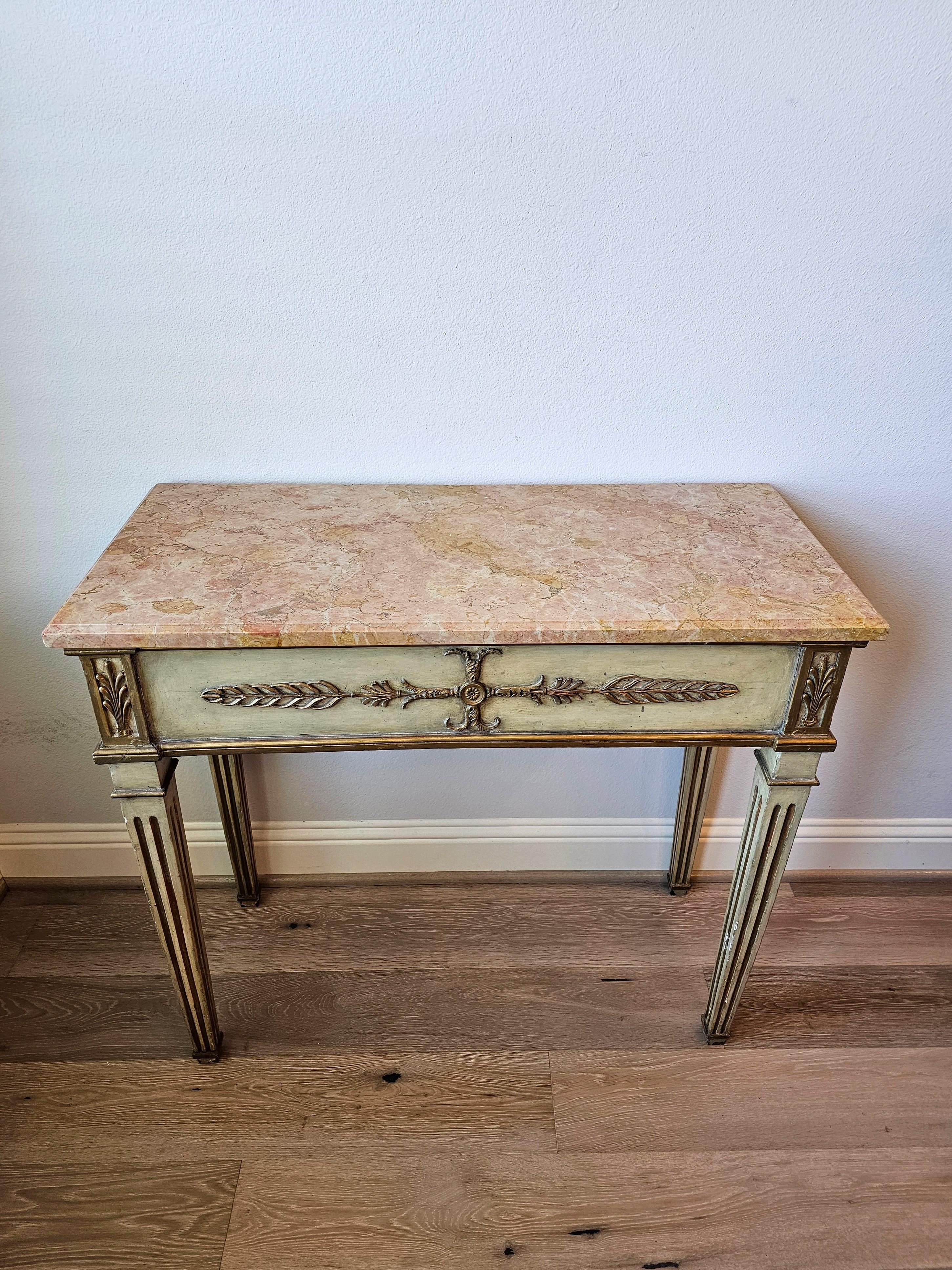 A stunning Swedish Gustavian period (1772-1809) console table.
 
Hand-crafted in Sweden in the early 19th century, Louis XVI Neo-classical taste, the muted dark cream with pale greenish undertone painted pine frame finely decorated with gilt gold