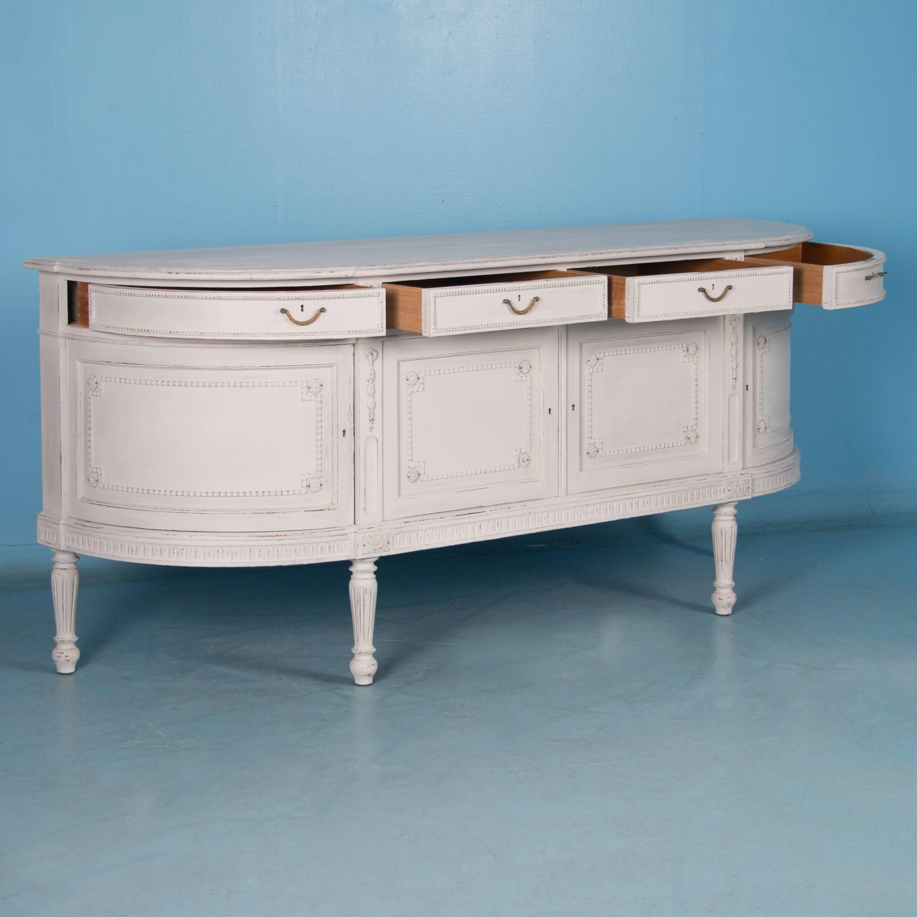 The wonderful proportions are enhanced by the distressed white chalk paint finish on this elegant Gustavian style sideboard from Sweden. The new white paint has been lightly scraped exposing the natural wood beneath and highlighting the applied