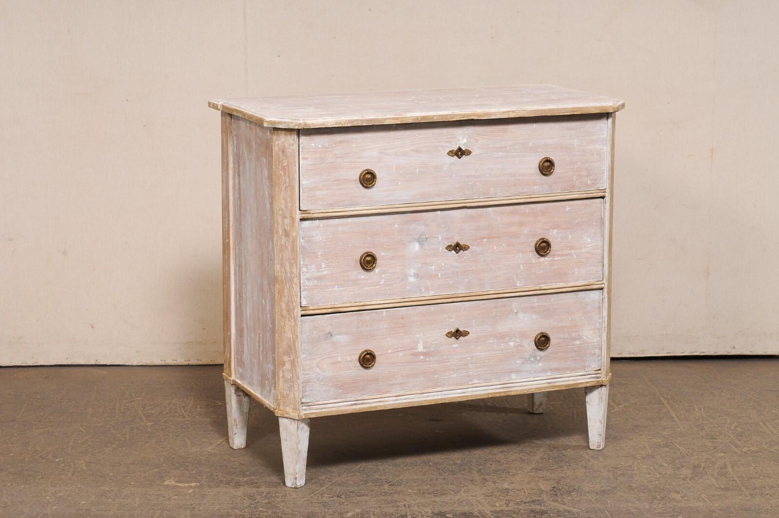 A Swedish Gustavian style wooden chest from the turn of the 19th and 20th century. This antique chest from Sweden, in typical Gustavian style, features a simple, clean design with a slightly overhanging top, whose front corners have an