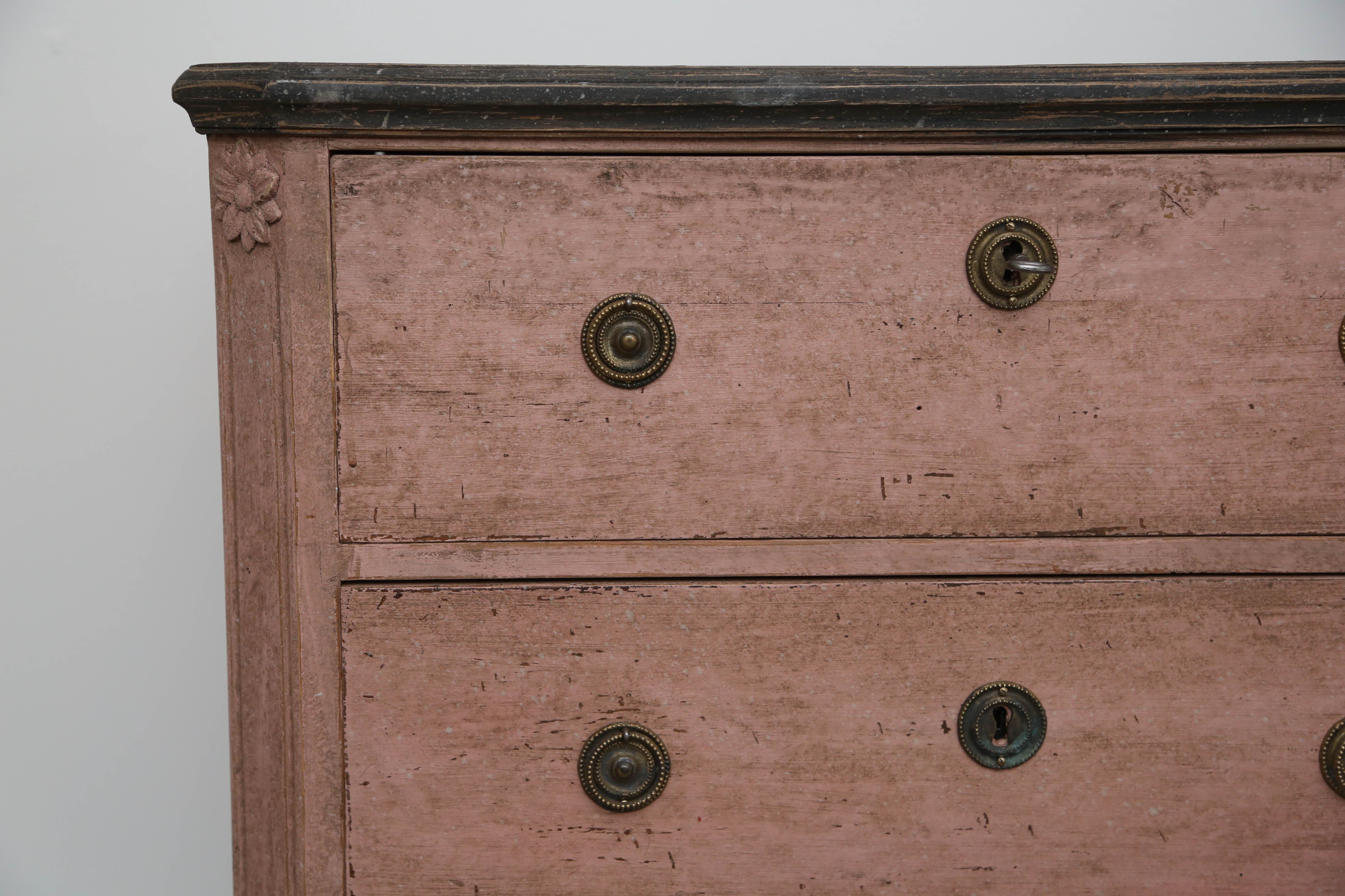 Pair of antique Swedish Gustavian style rose distressed painted chests. The tops are faux painted in dark greyish marble and extends down to the carved crown border, cut fluted carved corners with a rosette at top, ending in tapered fluted feet.
