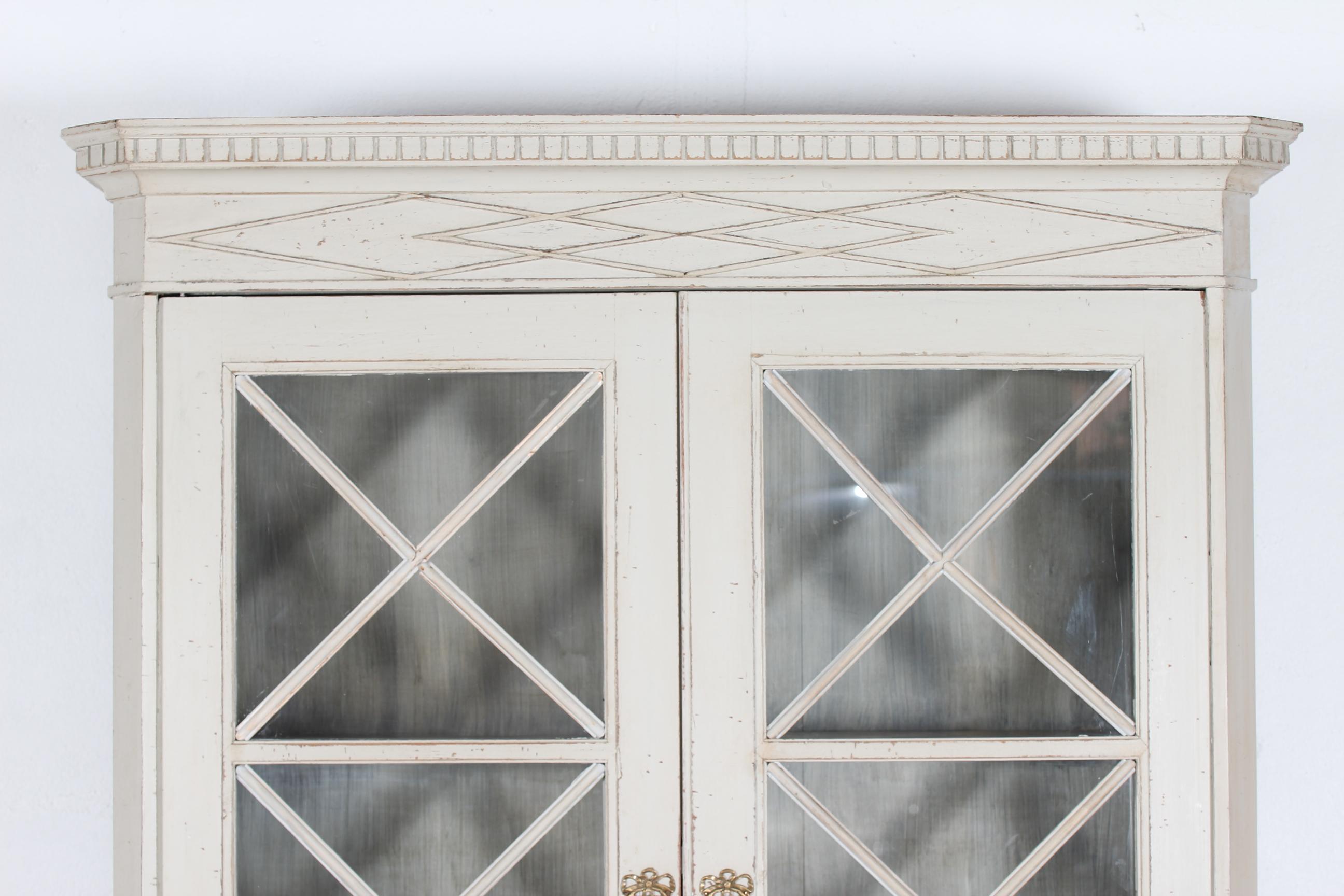 Large grey antique Swedish Gustavian vitrine cabinet with delicate details and brass fittings. 
Handmade by a swedish cabinetmaker of solid pine, later hand painted with grey paint with patina.

Upper part with glass doors with bars, lower part with
