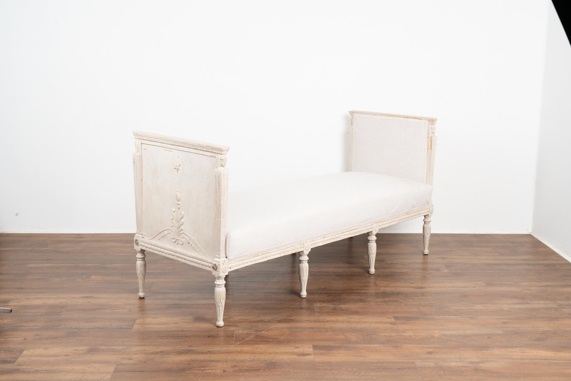 This exceptional sofa or settee is from the Swedish Gustavian period with white paint and exquisitely carved details including the side panels.
Please enlarge and examine the close up photos to appreciate the softly distressed white of the newer