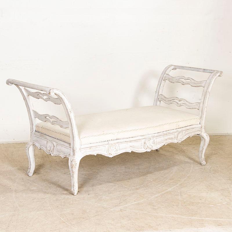 This is a truly exceptional sofa or settee of the Swedish Gustavian period due to the beautiful original white paint and carved details. Please enlarge and examine the close up photos to appreciate the softly distressed white of the main body and