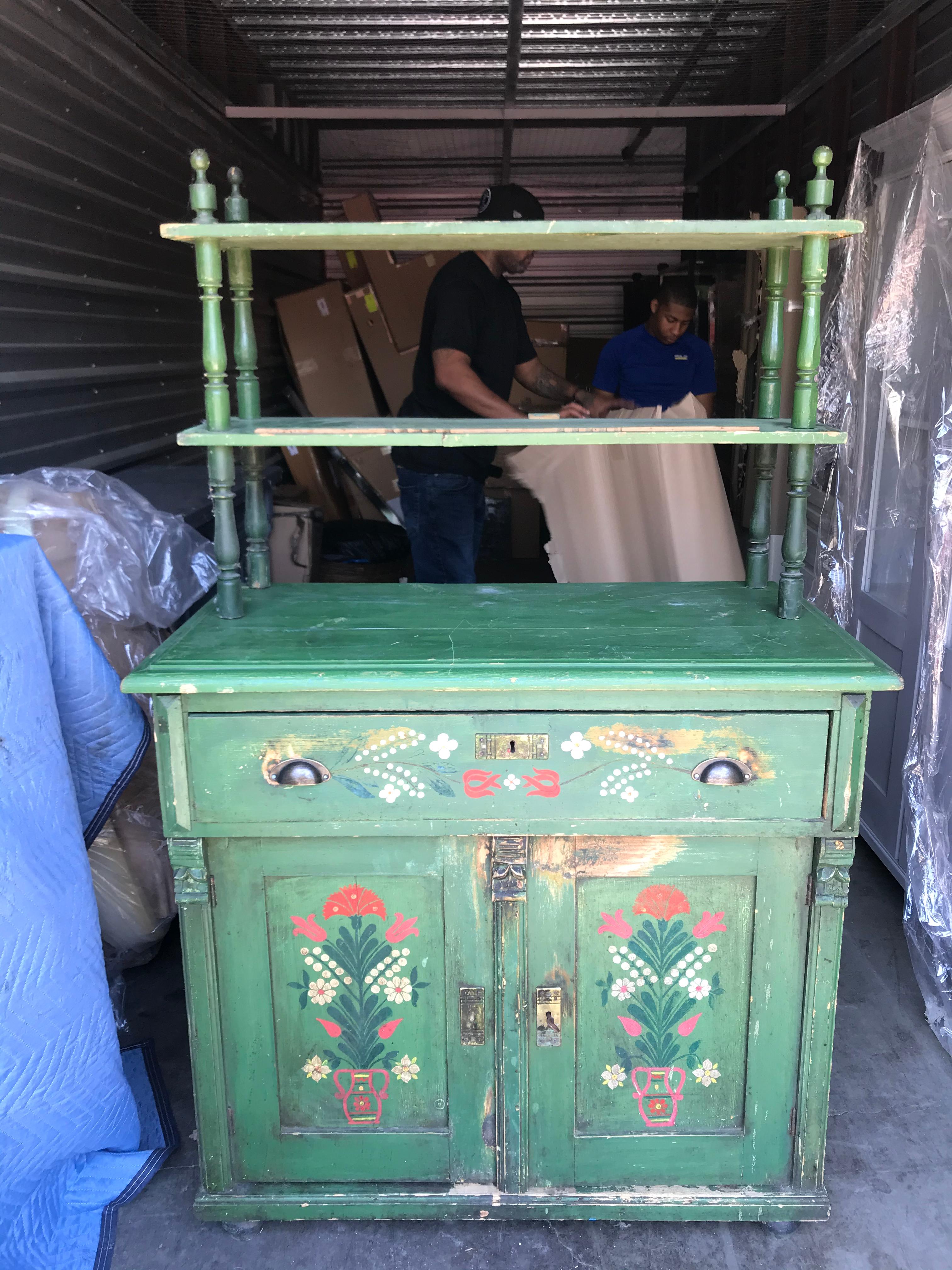 A amazing piece of art that embraces the Scandinavian Folklore and the accessibility of furniture. This antique Swedish hand painted hutch is coated with a vibrant green and embellished with hand painted flowers. A petite built perfect for any home.