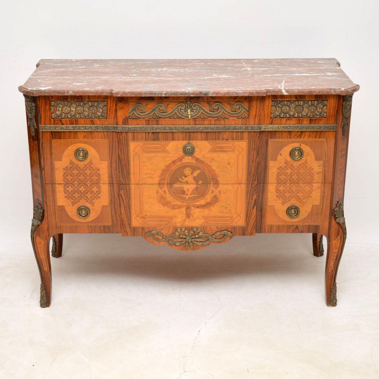 Antique Swedish marble top commode made up from many different woods, including rosewood, kingwood, satin birch, walnut and many other exotic woods within the inlays and marquetry. It’s in good condition and dates to around the 1910 period. The