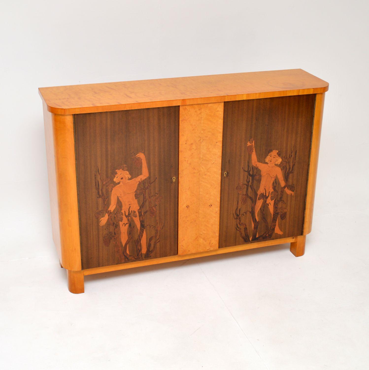 A stunning antique Swedish inlaid satin birch cabinet, dating from the 1920’s.

This is of outstanding quality, it is beautifully made and is a very useful size. It is predominantly satin birch, the doors are walnut and have inlays of various woods,