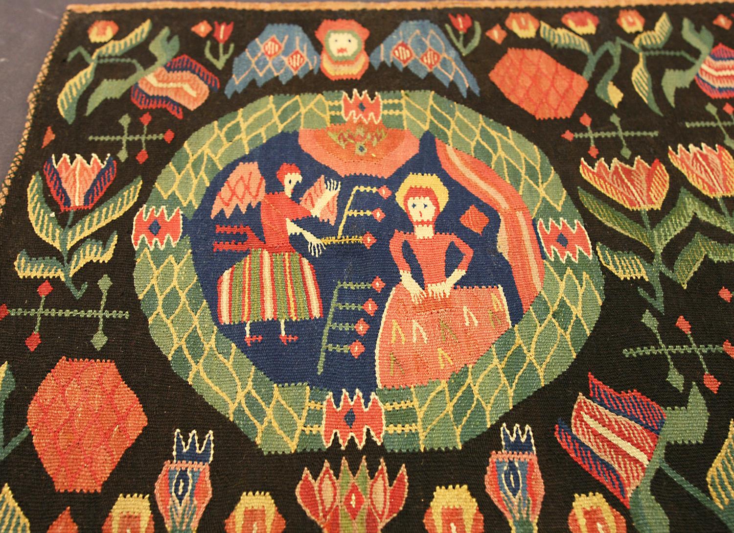 Tan France auction Pick

This is an antique Swedish textile woven during the 19th century that measures 96 x 51CM in size. this textile has a horizontal format with a pictorial design of a lady being greeted by an Angel with wings enclosed Within a