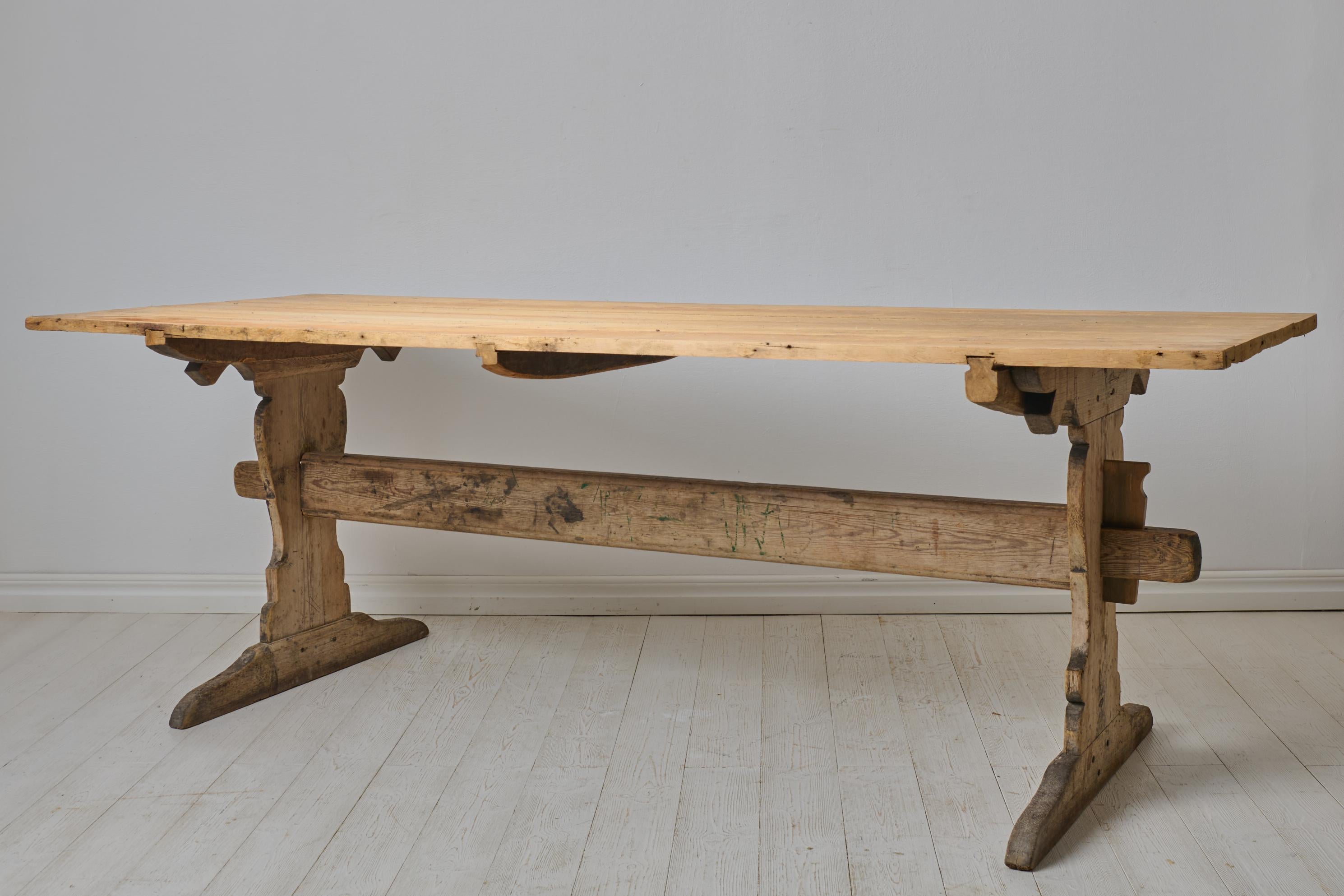 Grande table de salle à manger ancienne, dite table à tréteaux, du début des années 1800. La table est fabriquée en pin massif dans le nord de la Suède vers 1820. État d'origine intact, avec détresse et patine naturelles après 200 ans d'utilisation.