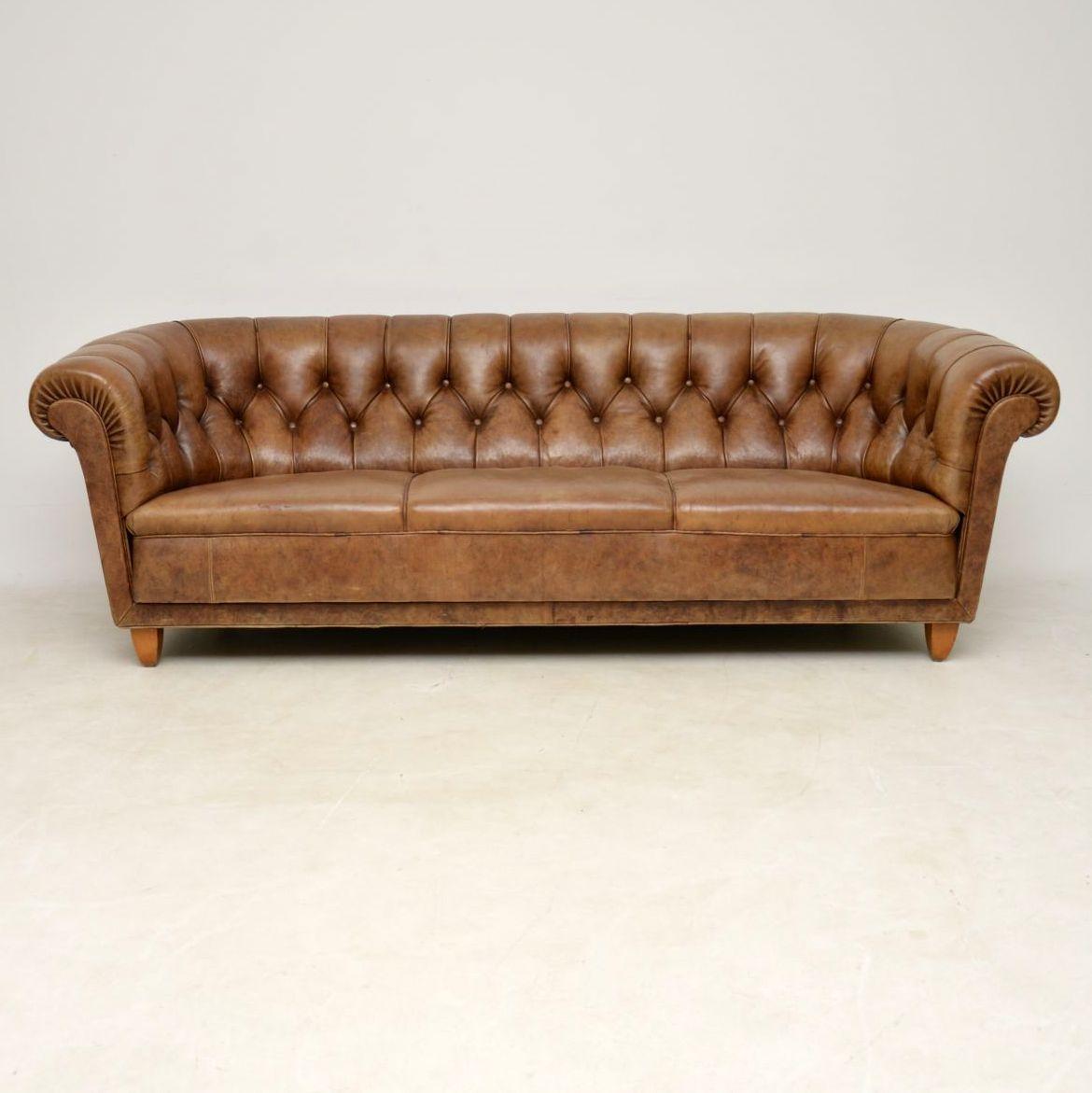 Very stylish looking antique Swedish three-seat leather Chesterfield in good original condition and with a wonderful color, plus loads of character. This Chesterfield is basically a Swedish take on the classic English version. I think the only way