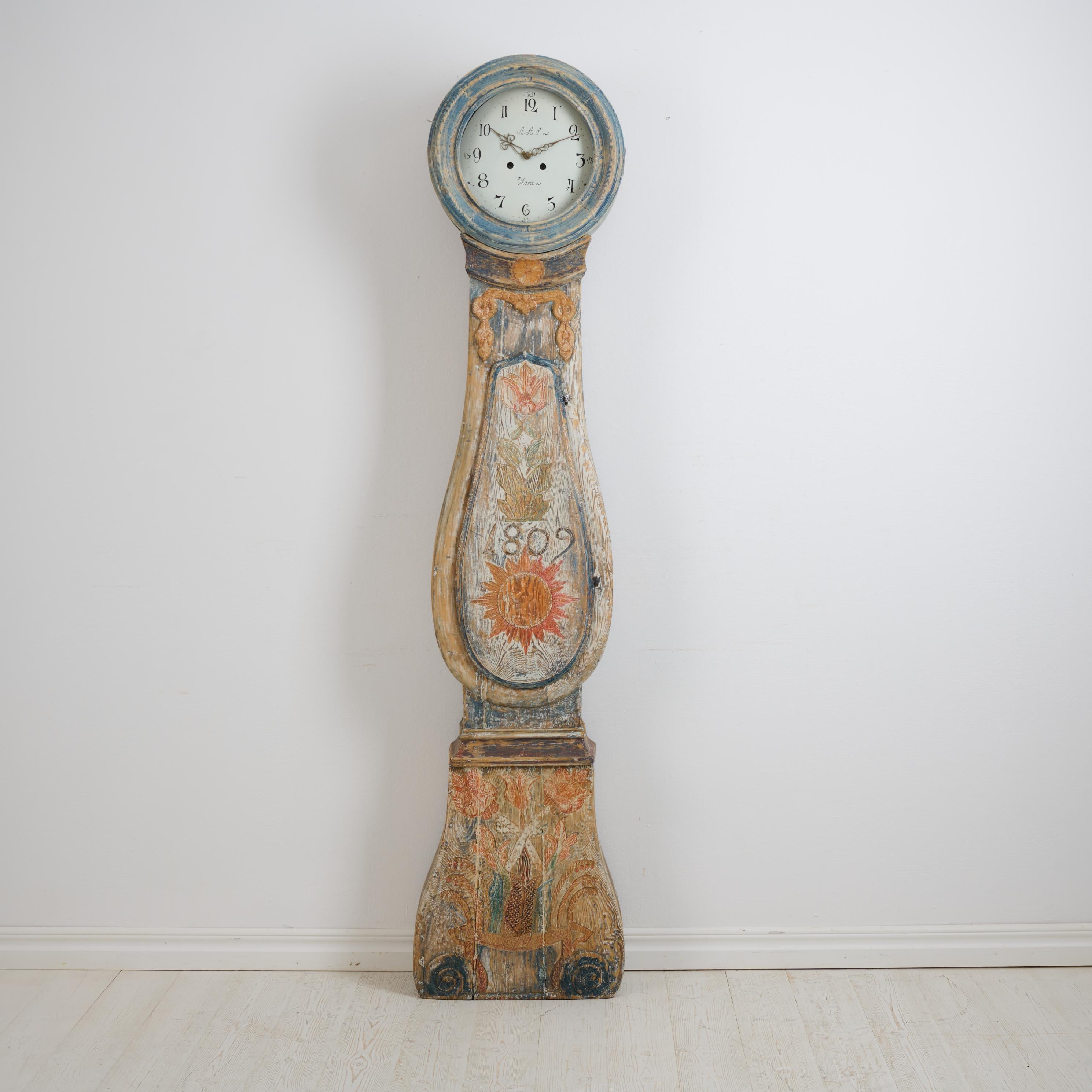 Antique long case clock from Sweden dated 1809 with unusual, original decor. Frame made by hand in solid pine with the original first layer of paint and very unusual decor. Some decor is also wood carved relief, see pictures.

Original mechanical