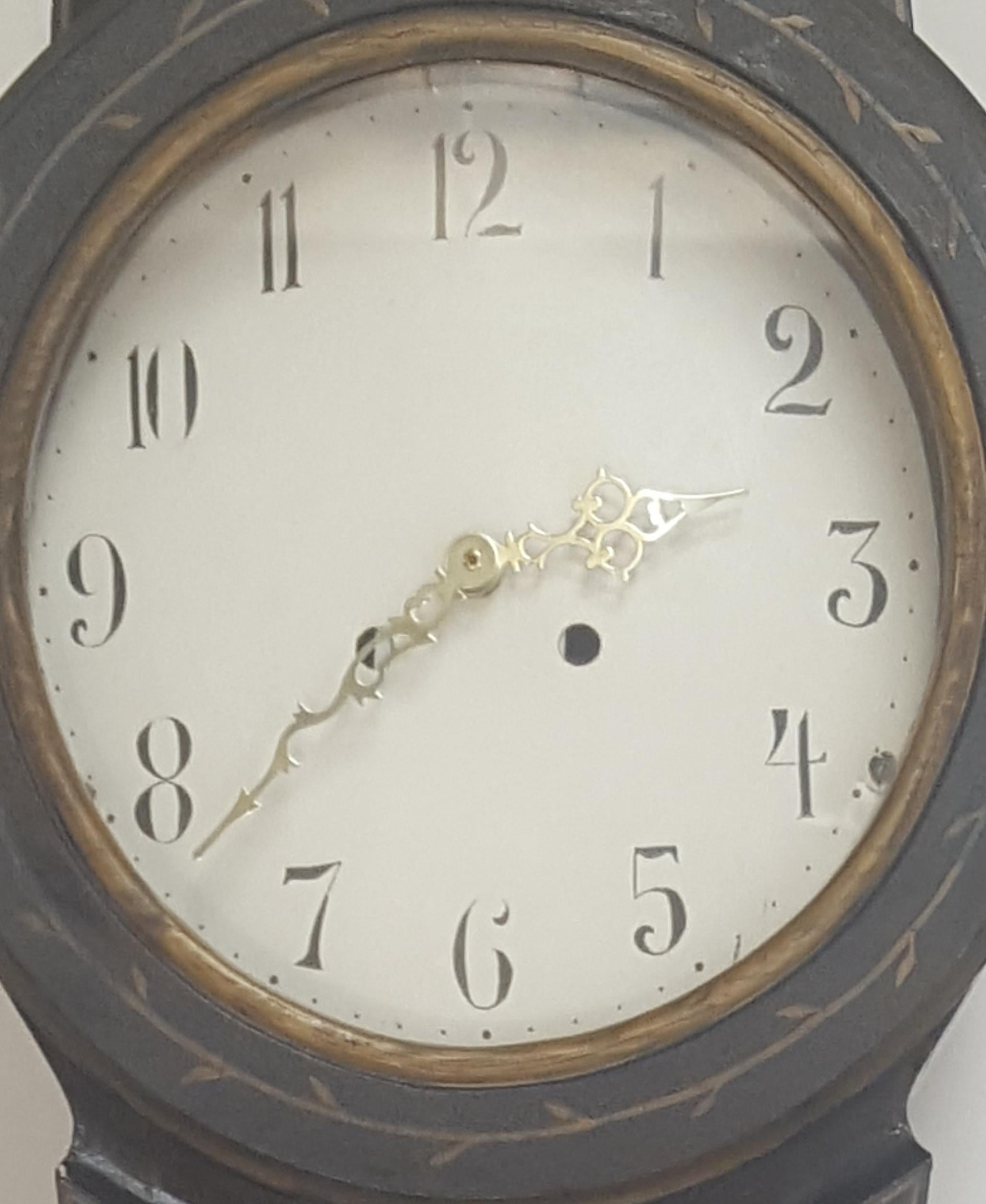 Antique Swedish mora clock from early 1800s in original black paint with hand painted gold designs and decorative face.

The clock body paint has the usual distressing/cracking and wood movement found in clocks of this age. 

We will fit a