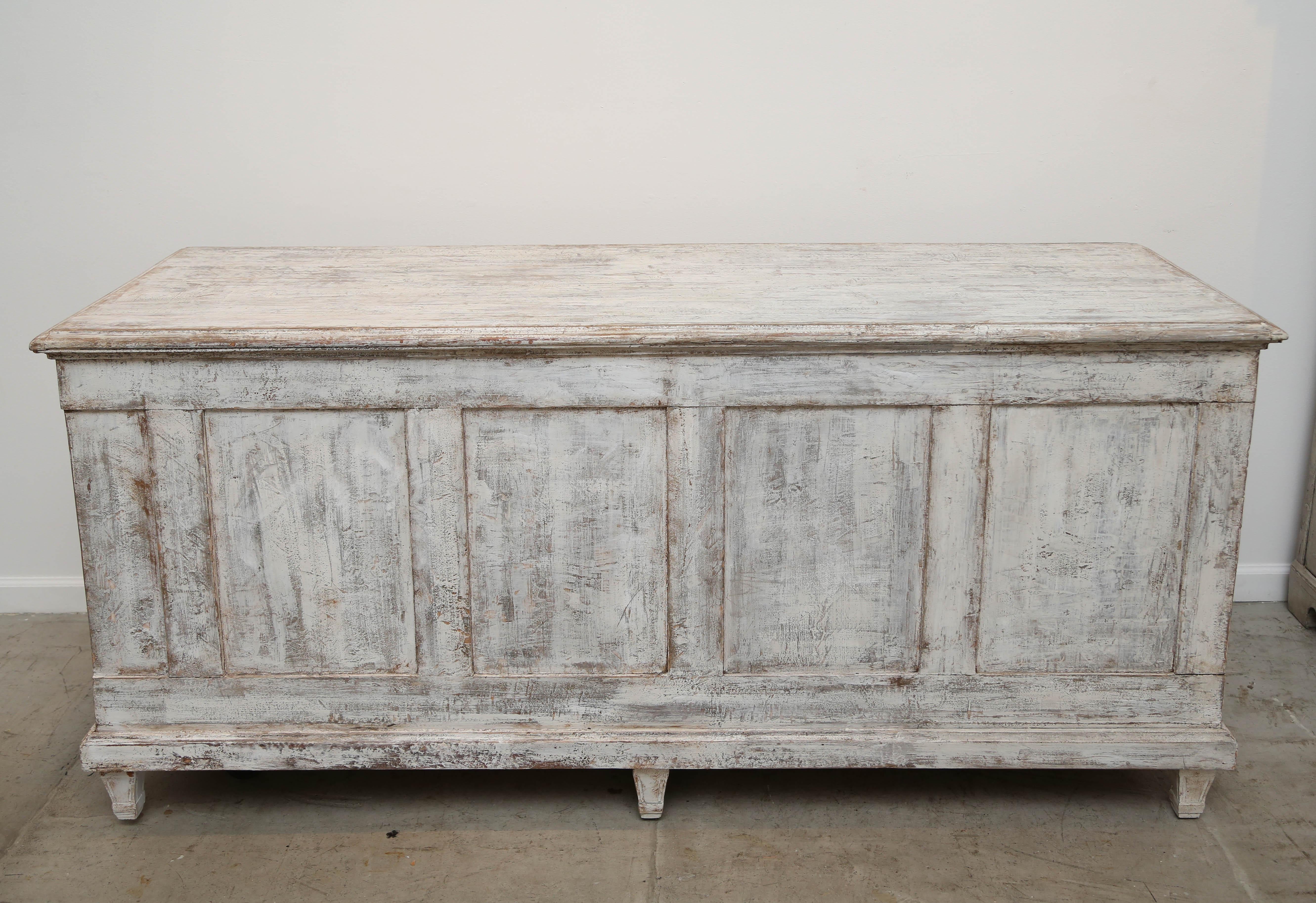 Unique and unusual 15-drawer apothecary cabinet or sideboard that sits on six fluted legs.
Painted in a distressed Swedish white/ivory and dry scraped allowing for the natural wood patina to subtlety show through.
The back of the piece is finished