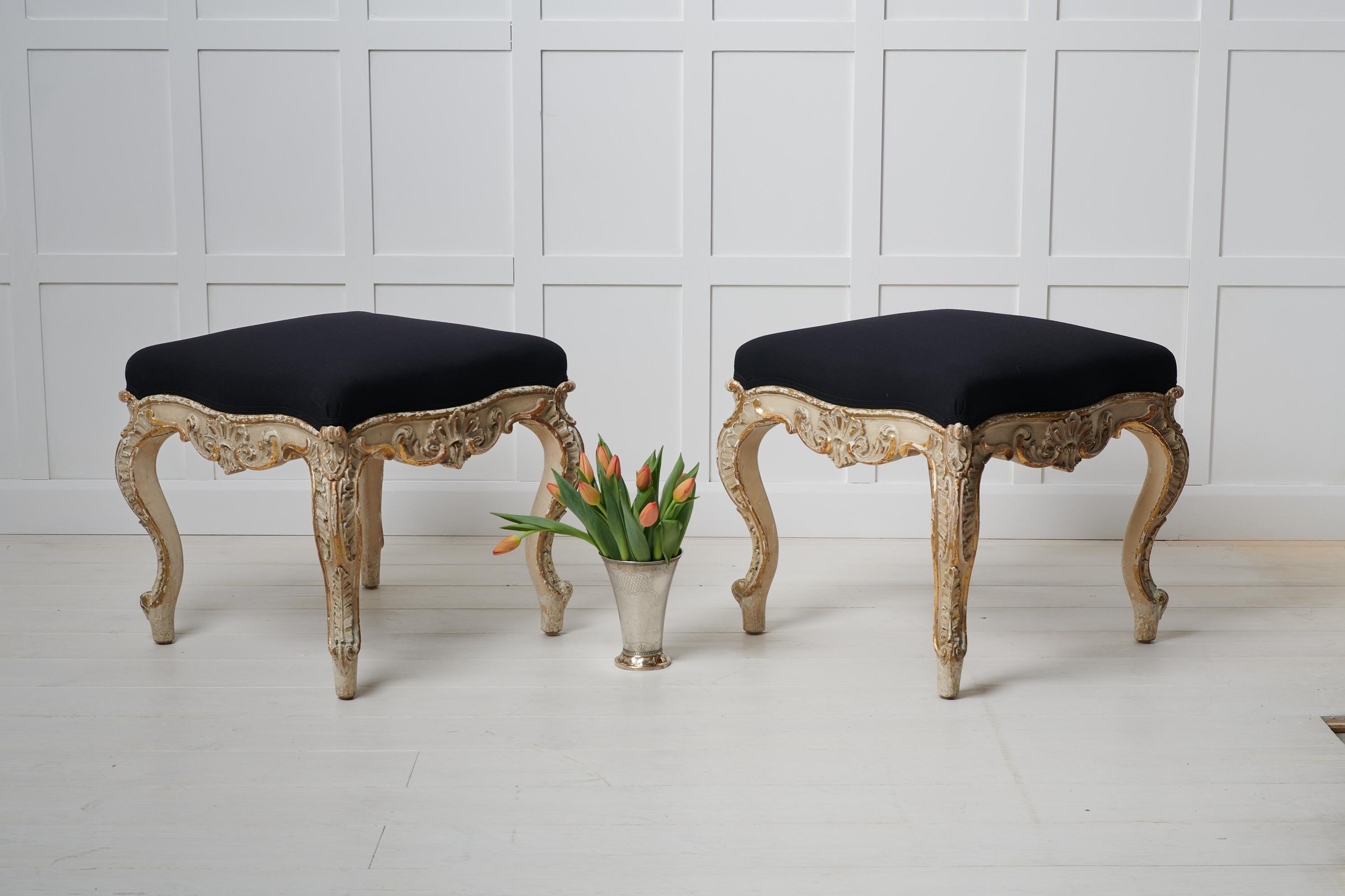 Pair of large upholstered stools in rococo style made during the rococo revival in the late 19th century. The stools are unusually large and have a frame in pine with old historic paint which has become distressed with time giving it a unique and