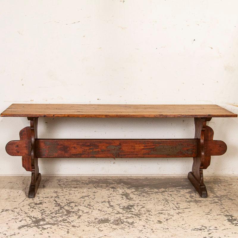 Your eye is immediately drawn to the warm pine patina on this Swedish farm table, beautifully distressed from decades of use. Constructed of solid pine with a trestle base, the broad stretcher and wide platform feet give this table strength and