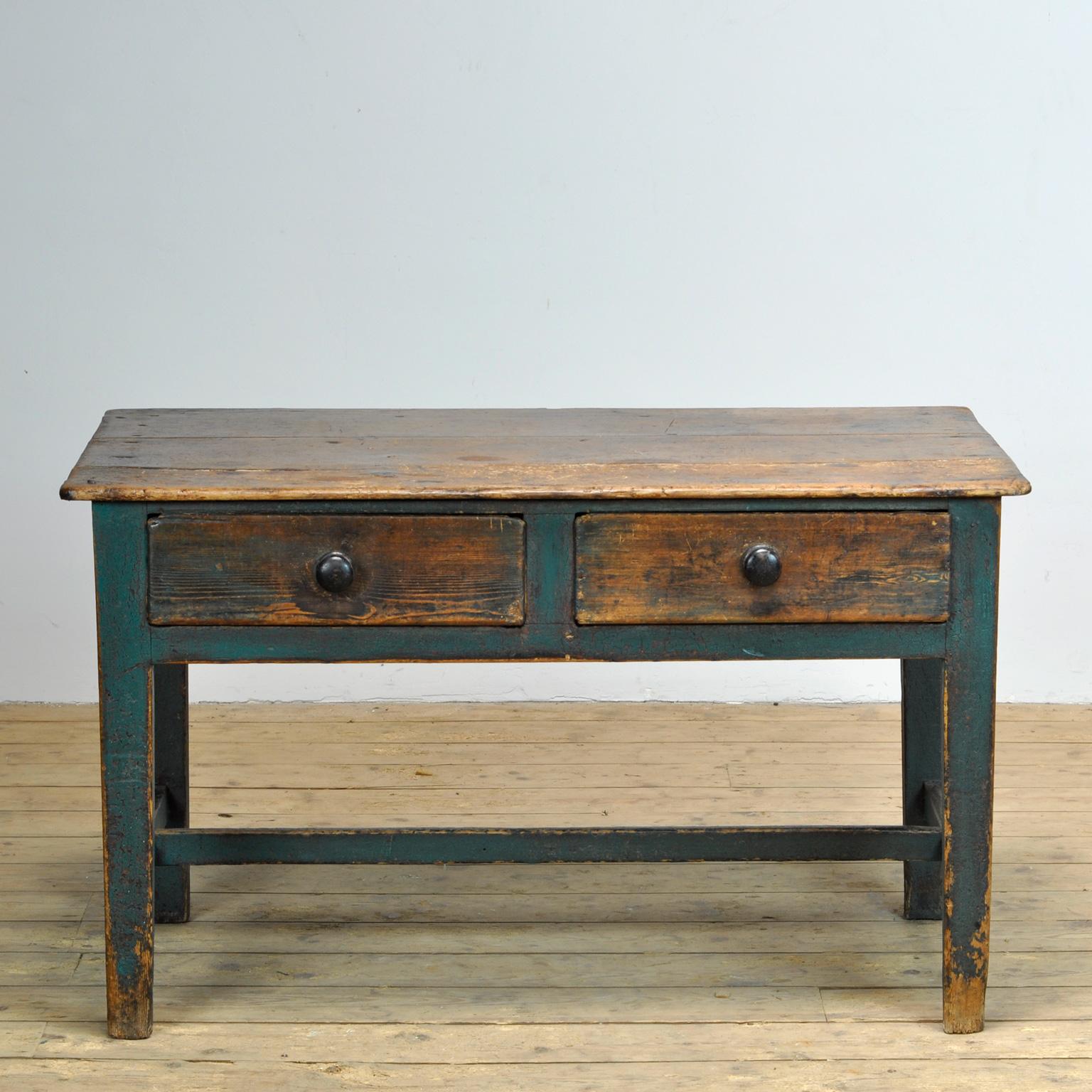 Mid 19th century Swedish painted farmhouse table. Equipped with two drawers with original knobs and beautiful patina. It has been left in its original condition. the top is slightly curved and has a beautiful weathered look.