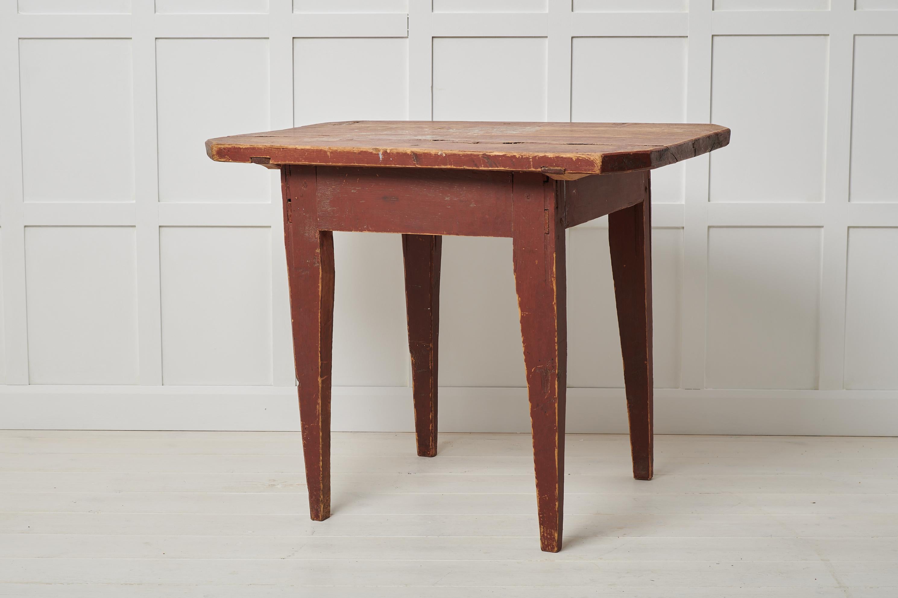 Antique Swedish primitive table in folk art. The table is a country furniture with a simple construction and a charmingly primitive appearance. The table is made by hand and is not completely symmetrical so the measurements vary slightly. The frame