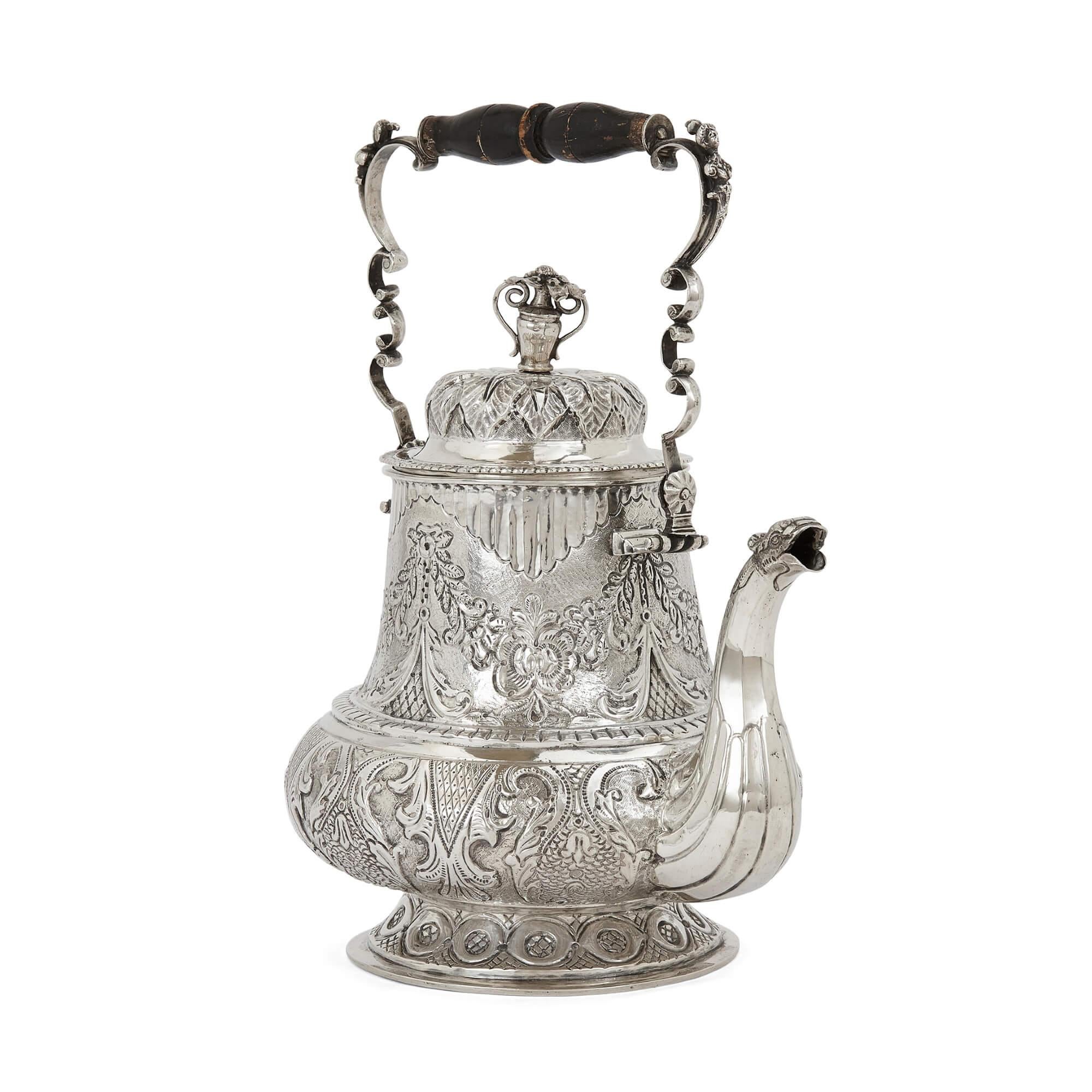 Antique Swedish repoussé and engraved silver teapot
Swedish, 18th Century
Measures: height 28cm, width 24cm, depth 17cm

This elegant Swedish teapot is designed in an ornate style and crafted from solid silver. The body of the teapot is