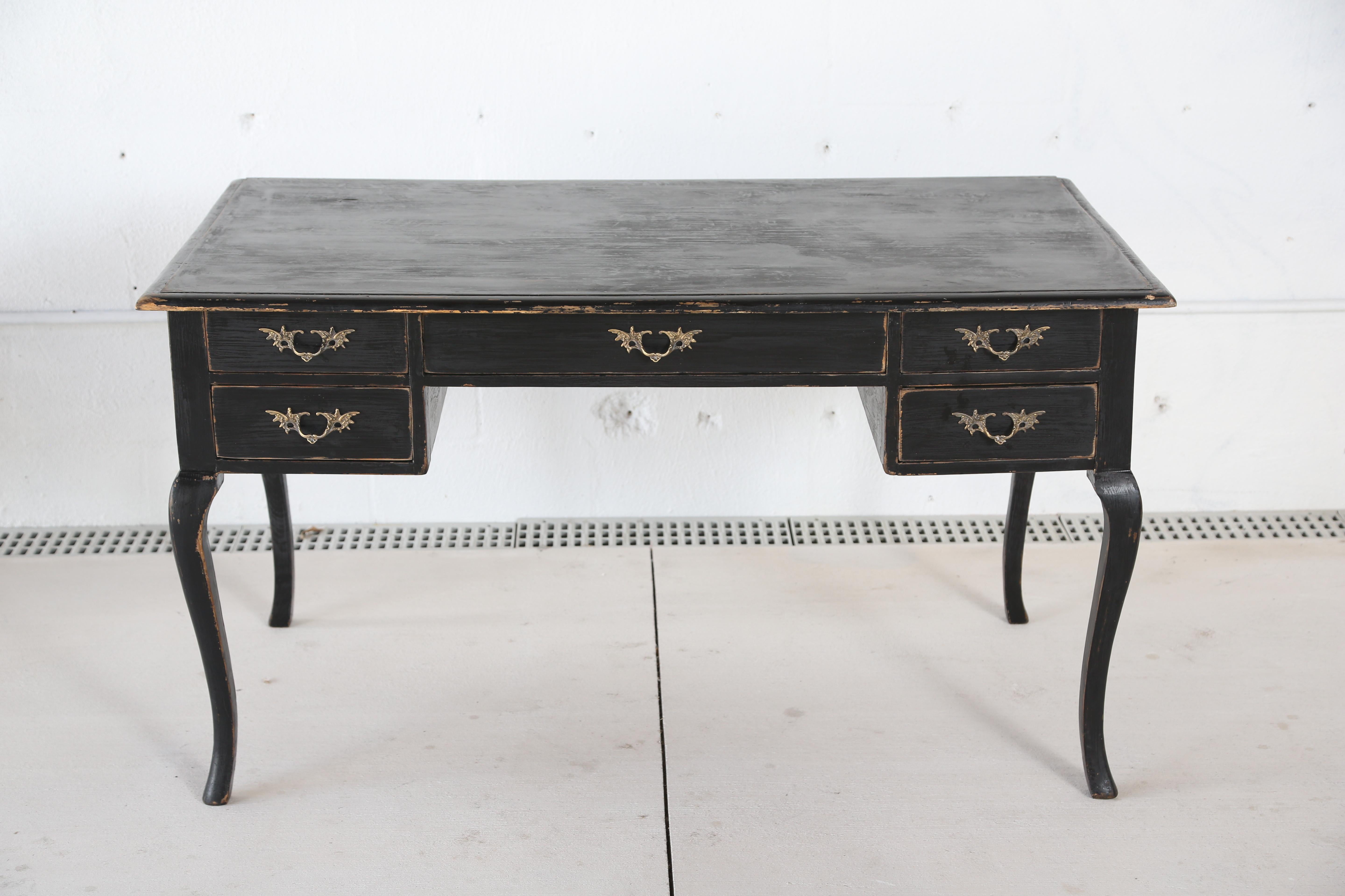 Antique Swedish Rococo Style writing desk in Black distressed paint finish, cabriole legs, five drawers with lovely carved brass hardware, simple half round top edge.

H 29