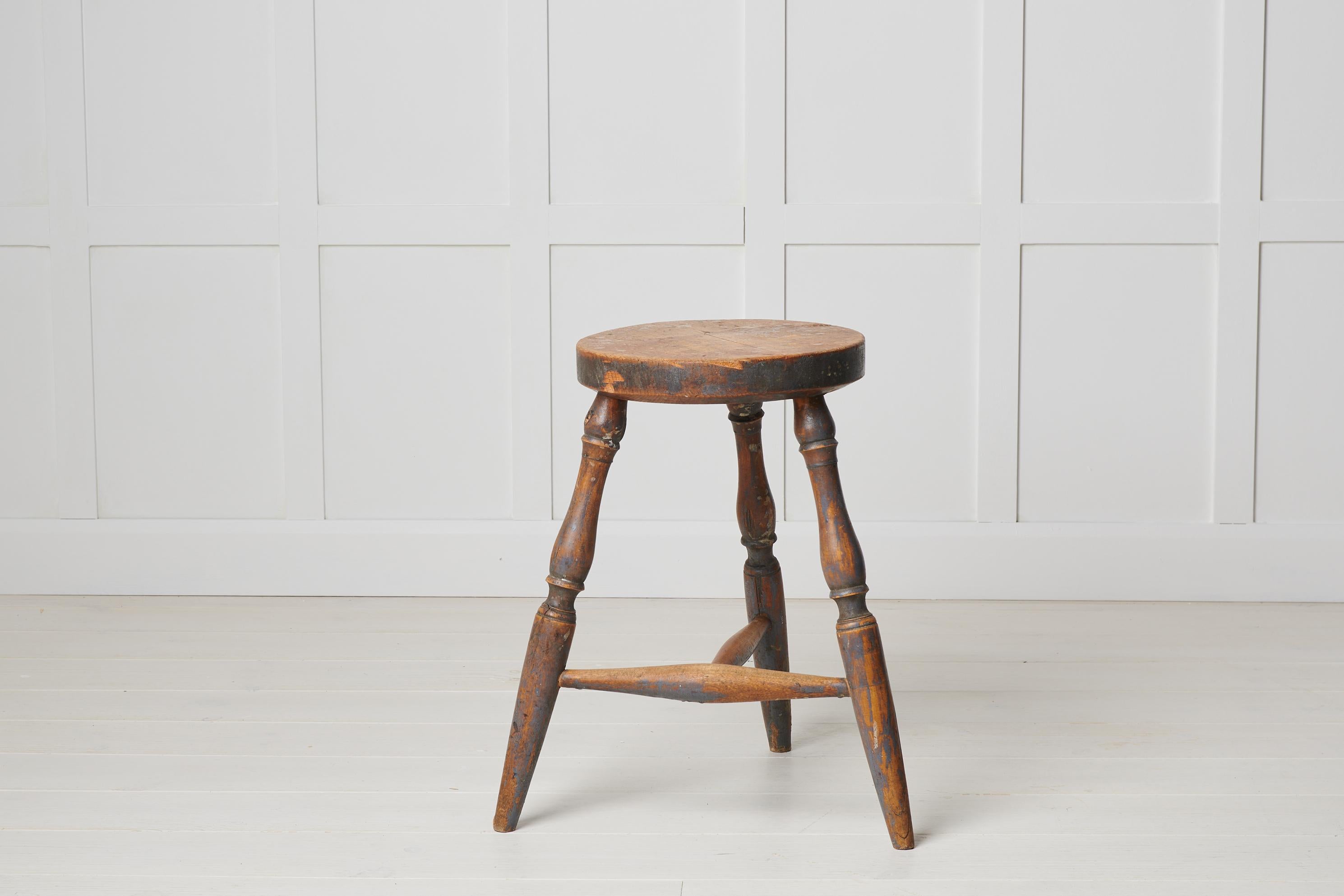 Antique Swedish country stool in folk art made with three legs. This stool is from northern Sweden and made around the 1860s. Older stools are commonly found to have only three legs, this because it was easier to make them stand stable on floors