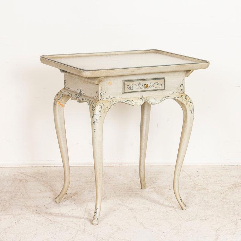 The graceful lines of the cabriole legs carry upwards through the attractive scalloped apron on this delightful Swedish side table. As seen in photos, on each side there is a small tray which extends, originally to hold candles. Now, this table may