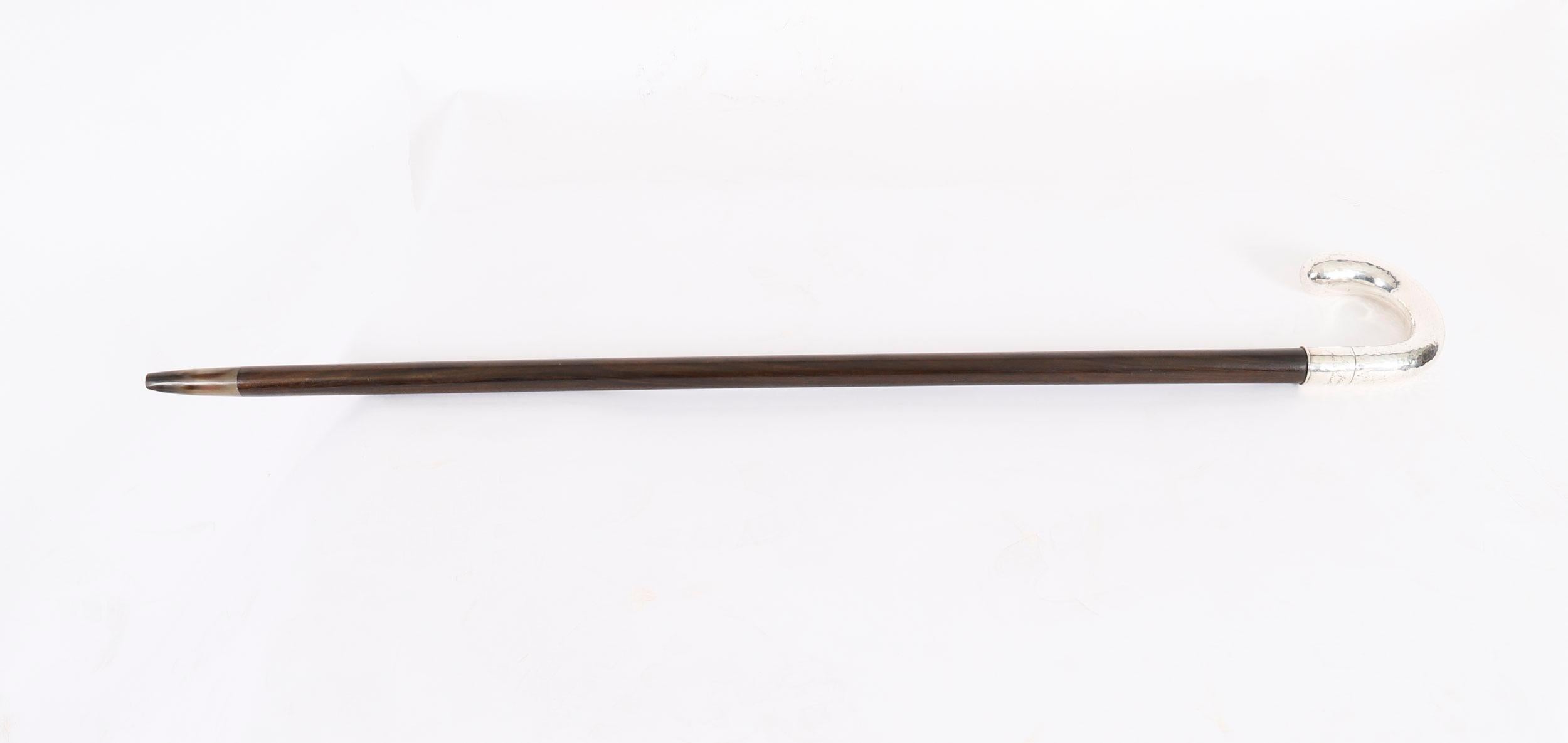 A handsome substantial antique Swedish silver handled walking cane with impressed hallmarks with the imported silver mark, 830s and the 800 minimum mark, circa 1860 in date.

The hammered silver hook shaped handle bears the engraved