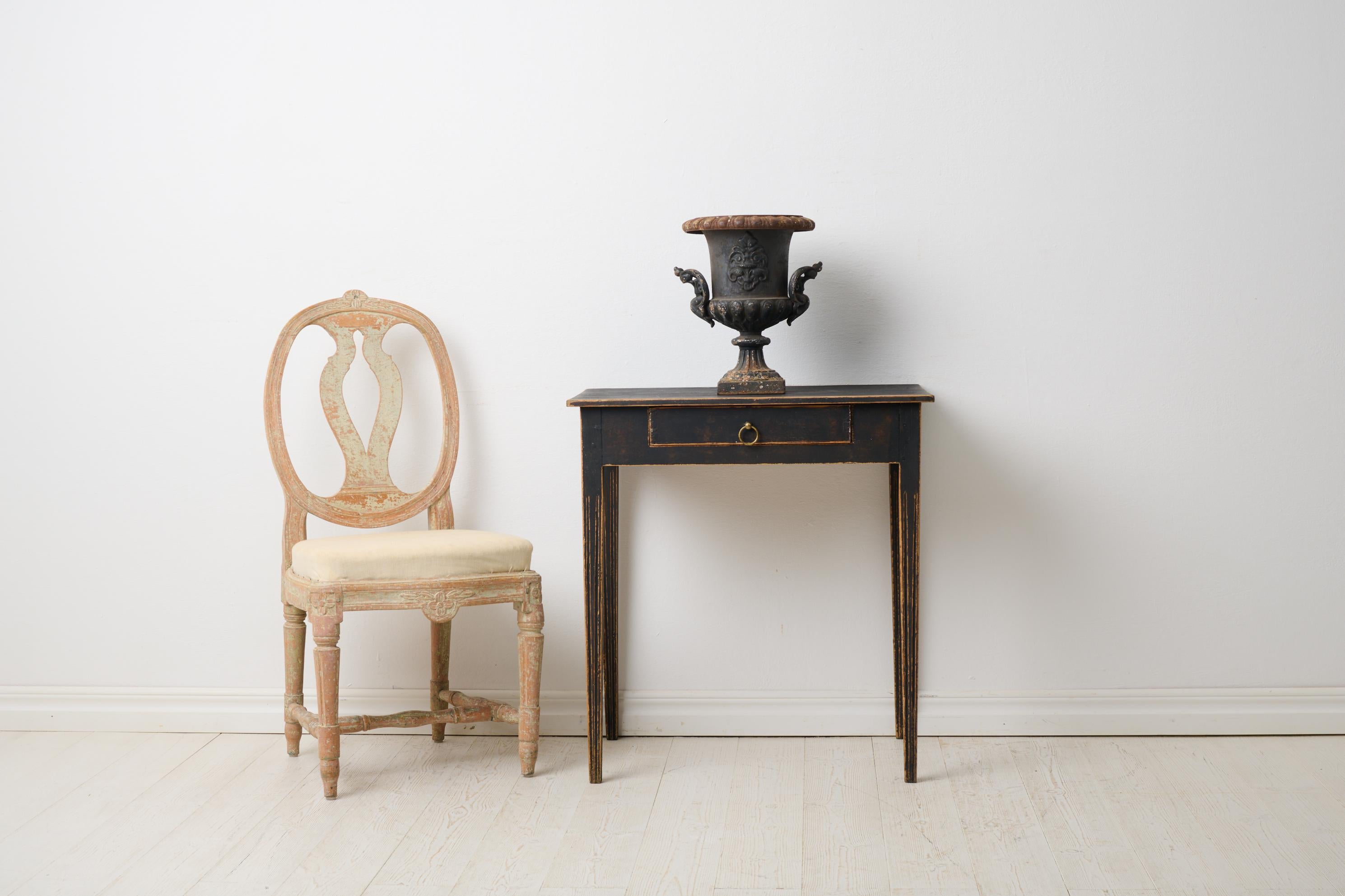 Swedish antique side table with a drawer in gustavian style. The table is small with a rectangular table top and a drawer in the apron. The legs are straight and tapered with flutes running top to bottom. Healthy and stable frame. Paint with