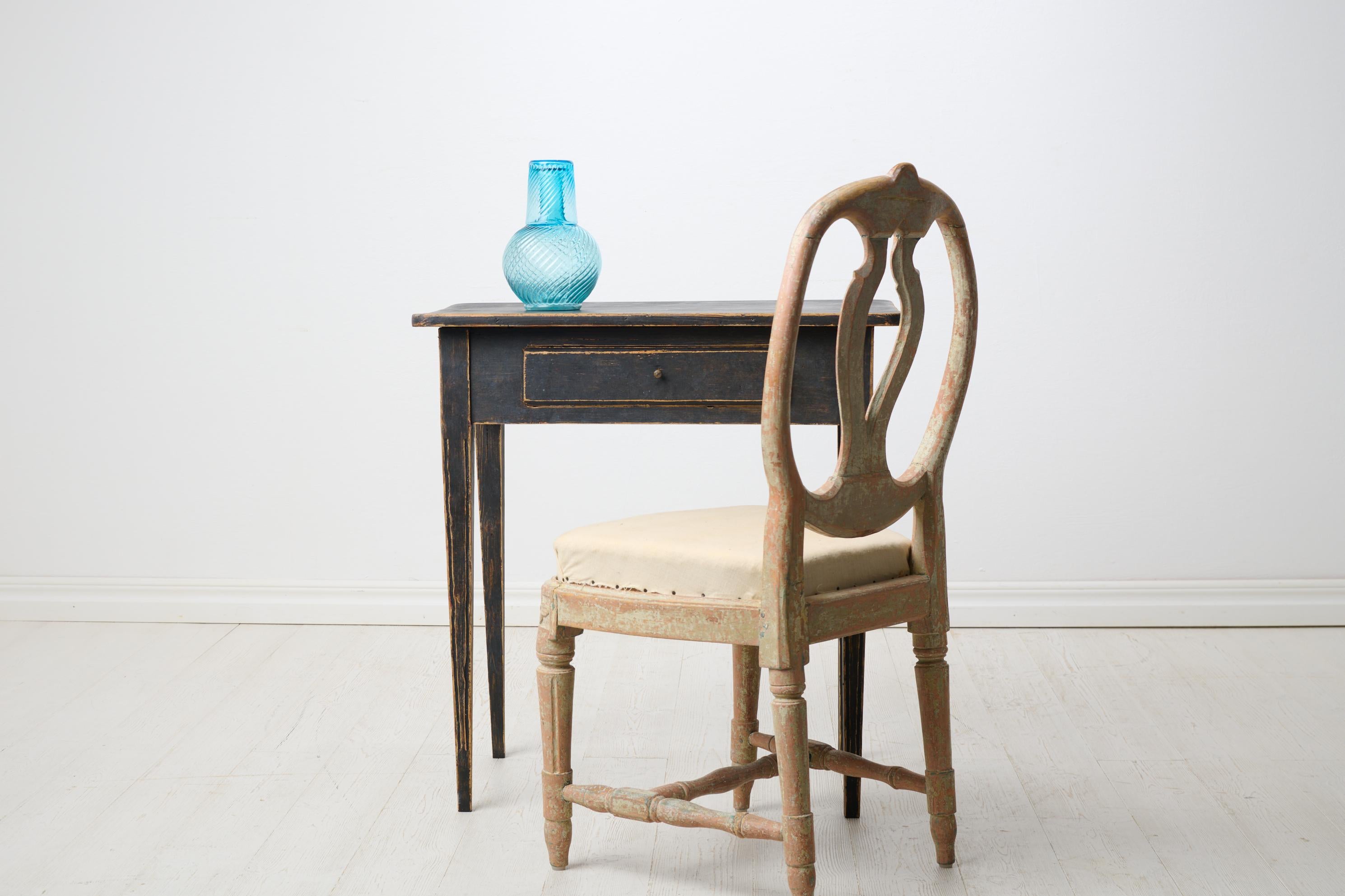 Swedish antique side table with a drawer in gustavian style. The table is small with a rectangular table top and a drawer in the apron. The legs are straight and tapered with flutes running top to bottom. Healthy and stable frame. Paint with