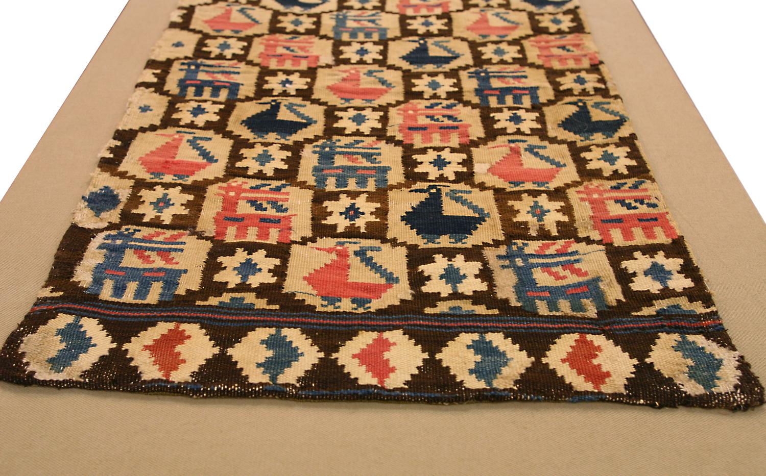 This is an antique Rollakan textile woven in Sweden during the 19th century and measures 90 x 47CM in size. the design of this piece is comprised of rows of alternating dears and Peacocks enclosed in a lattice design set on a beige background color.