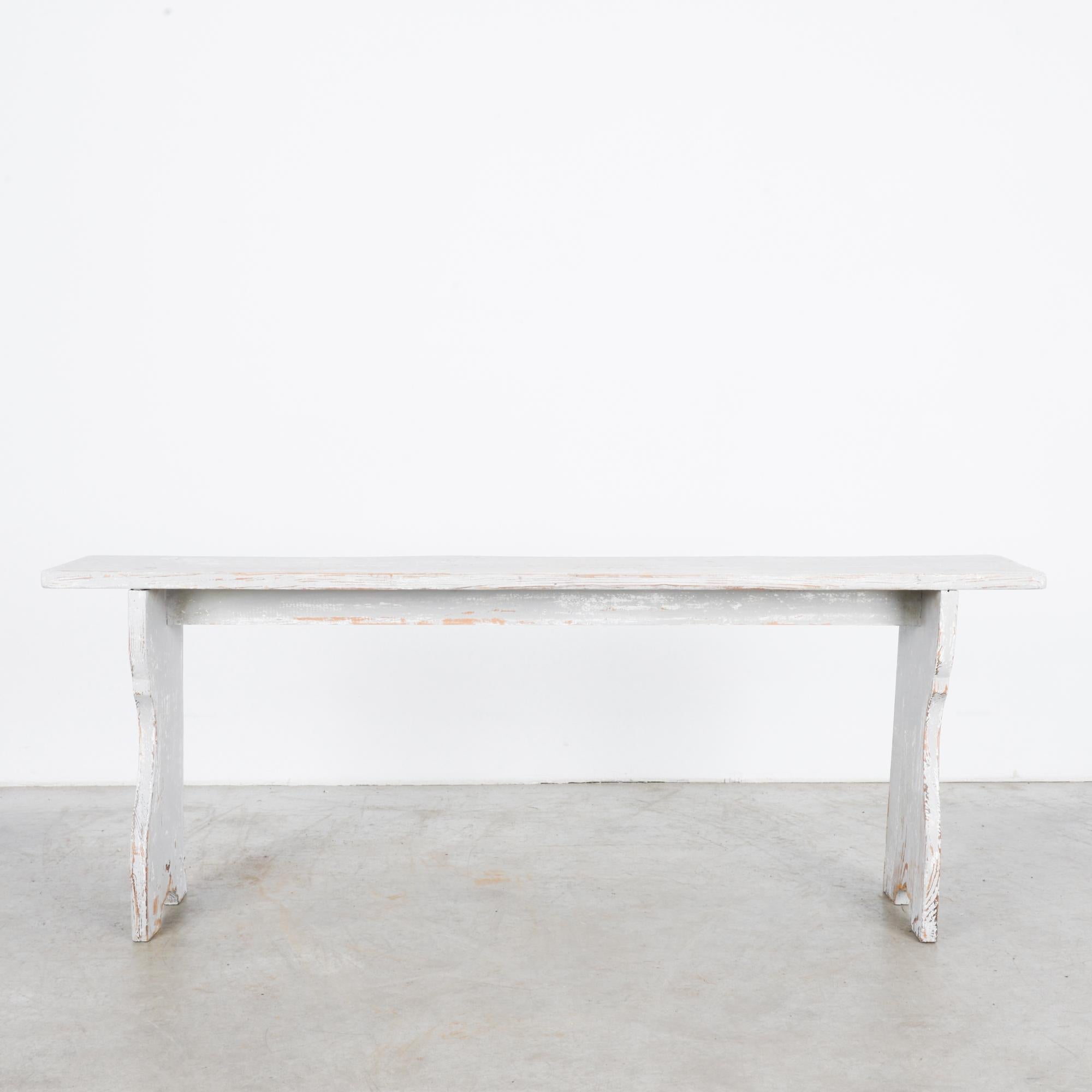 An antique white wooden bench from Sweden, circa 1900. Straightforward bench in classic Swedish folk style. Calls to mind promise of warm comfort while sitting down to take off your boots and mittens in dewy mudroom, bent double over pile of coats,