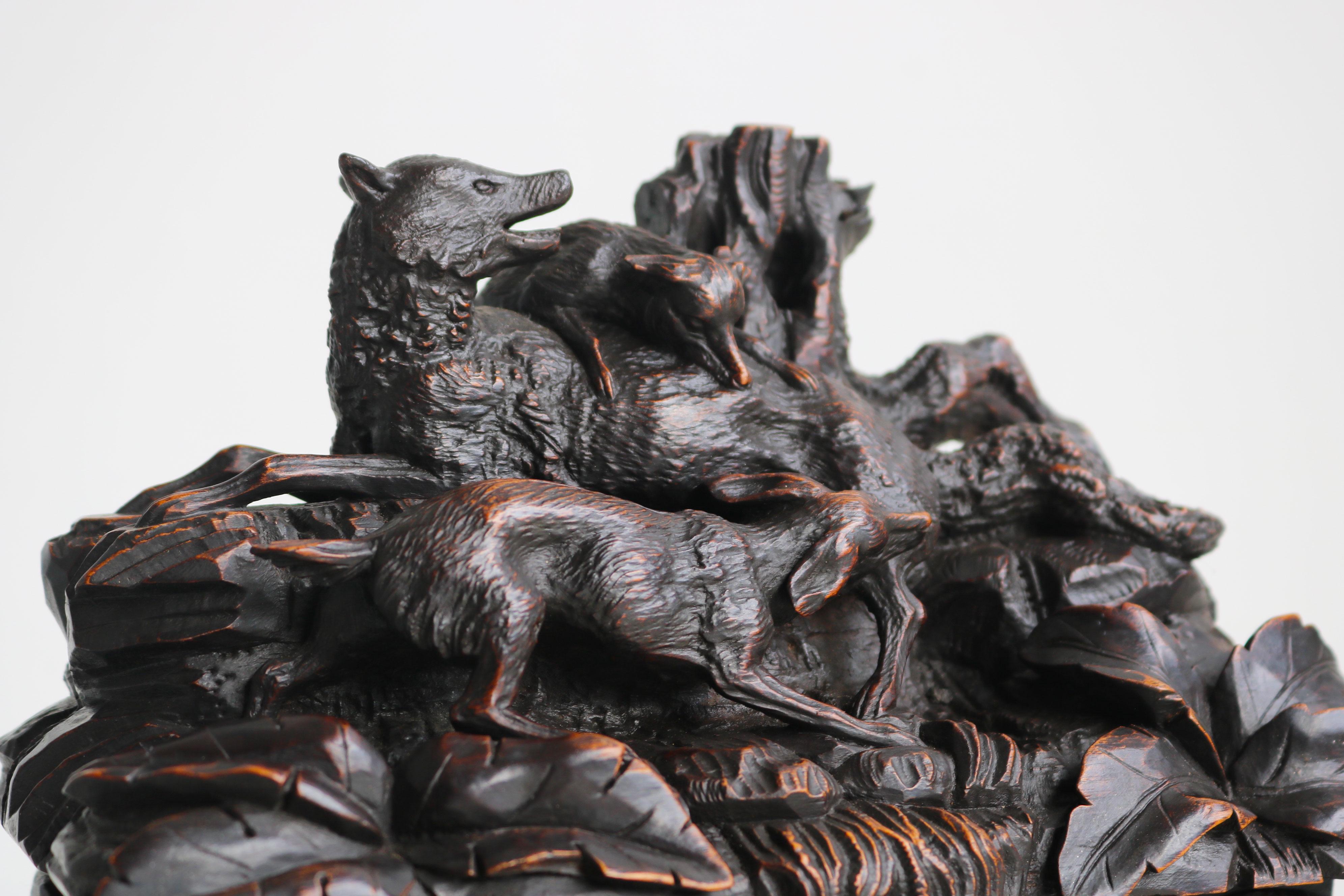 This extraordinary 19th-century Black Forest jewelry box from Switzerland is a true work of art. Nearly 150 years old, the wood boasts an incredible patina that only enhances its beauty. Crafted from a single block of wood, the box depicts a