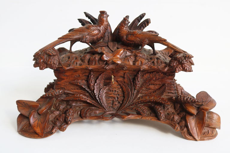 Simply breathtaking this marvelous 19th century Black Forest Jewelry box from Switzerland. 
Fully hand carved out of fruitwood by a master carver with superb attention to detail.
The jewelry box displays a gorgeous floral Black Forest setting with