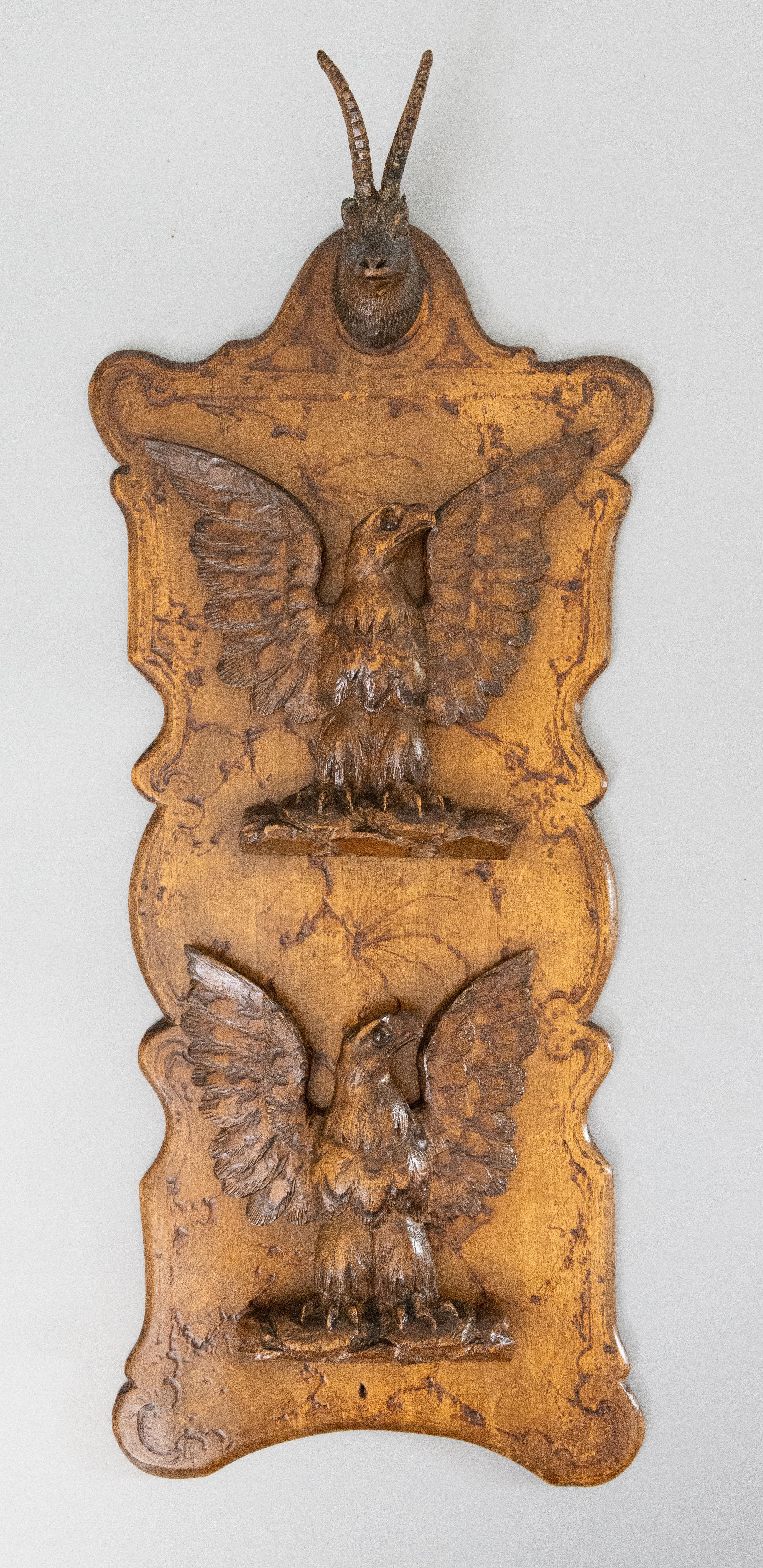 A rare antique Swiss Black Forest carved antelope and eagles wall mounted letter rack, circa 1900. This fine letter holder is a nice large size and has two eagles that fold out to hold letters, magazines, or personal documents. The eagles and