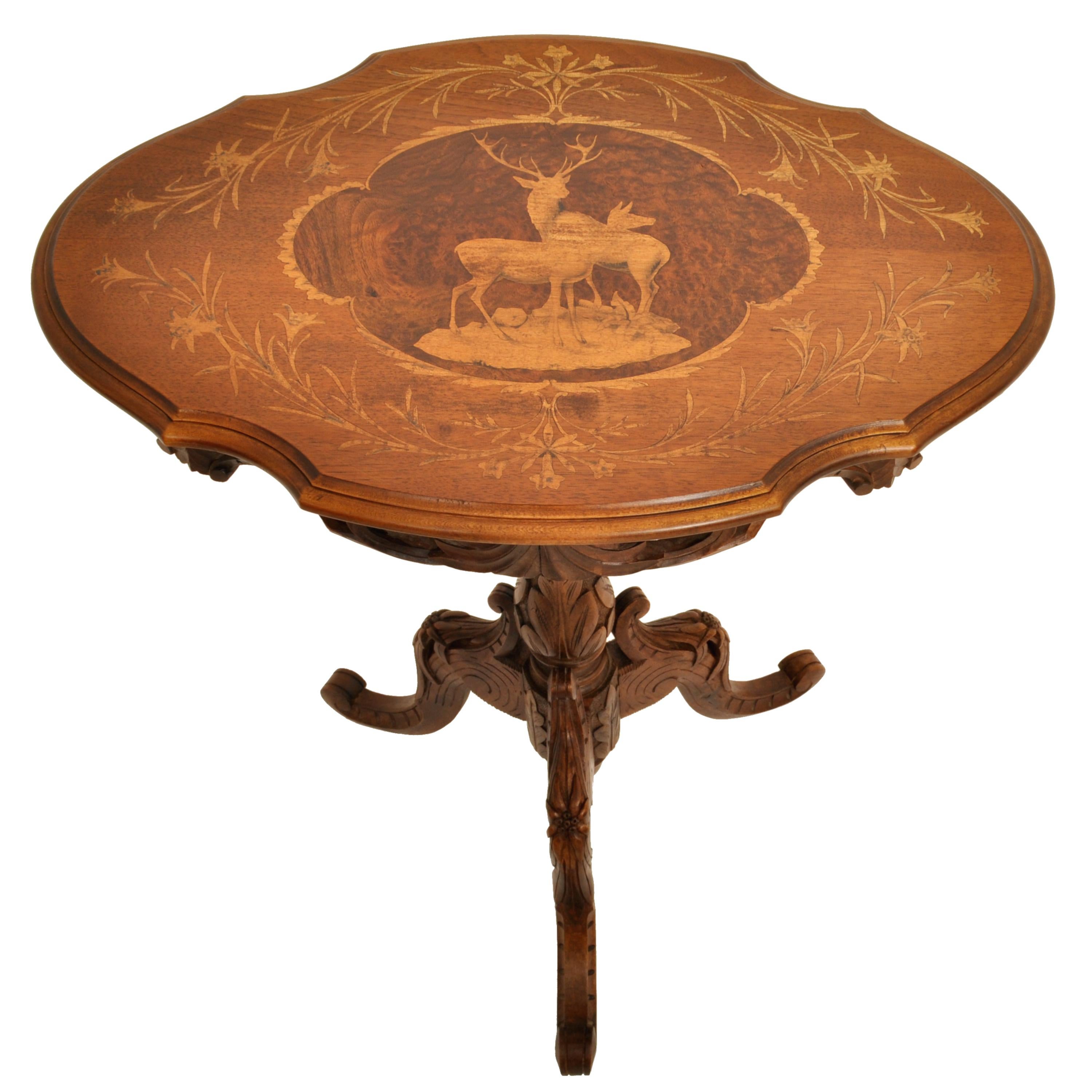 A good antique Swiss Black Forest marquetry walnut tilt-top table, circa 1870.
The table having a shield shaped tilt-top, that locks in place when in the down position. The table is finely inlaid in fruitwoods, having a floral design enclosing a