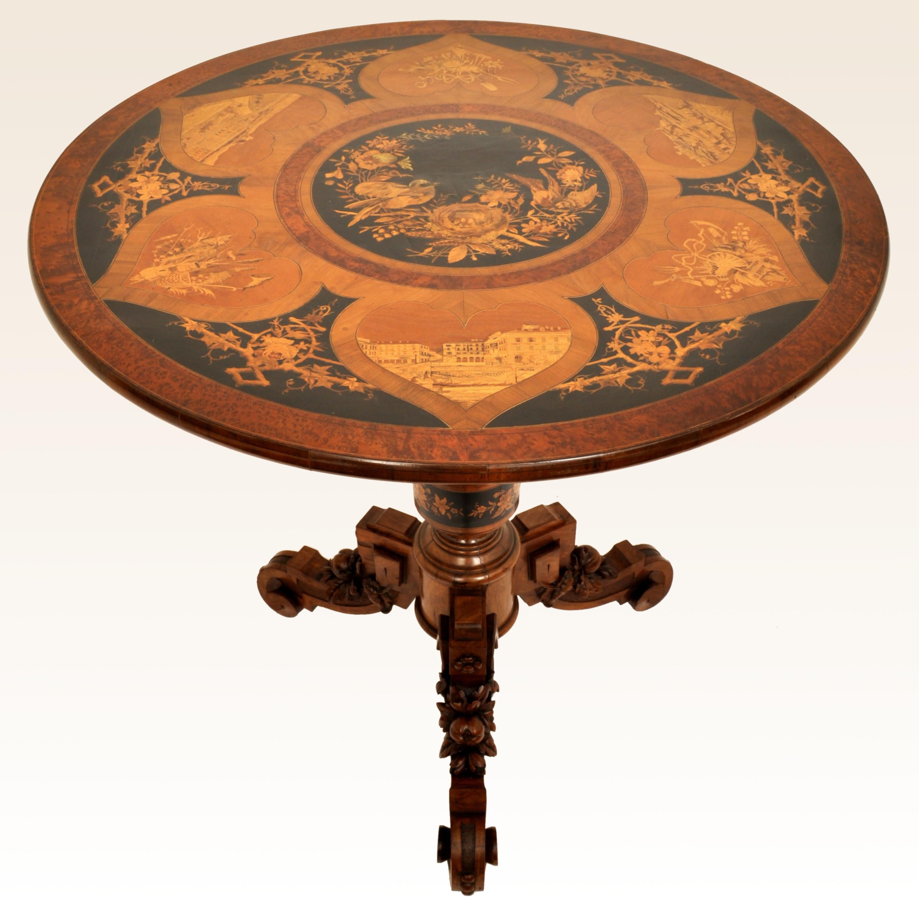 A very fine antique Swiss Black Forest tilt-top marquetry pedestal table, circa 1880. 
The table having a circular top with fruit-wood and ebony inlaid panels, the central panel having a pair of nesting birds, surrounded by six panels with