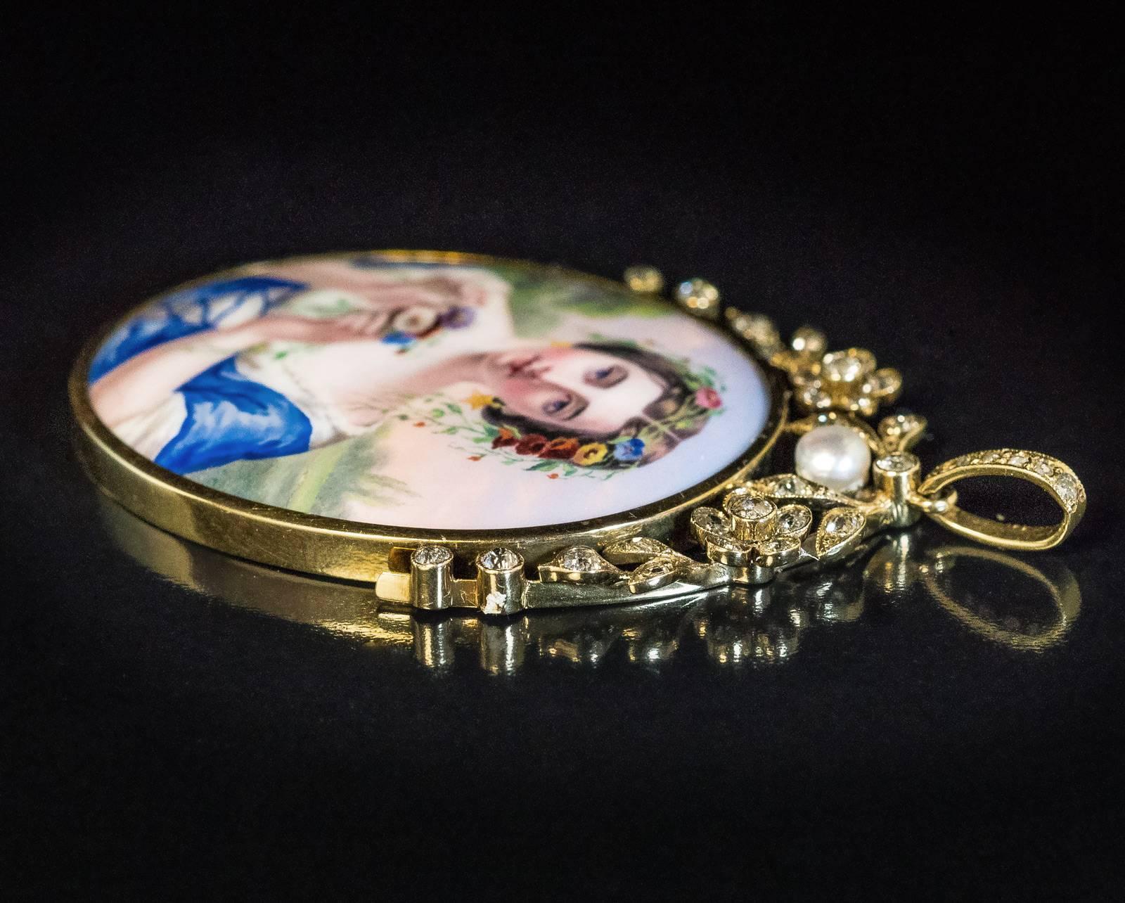 A large antique finely painted enamel miniature of a Swiss girl set in a 14K gold, diamond and natural pearl pendant, made in Geneva, Switzerland, c. 1860.

Estimated total diamond weight is 1 carat.

Total length with bail is 65 mm (2 1/2 in.)

The