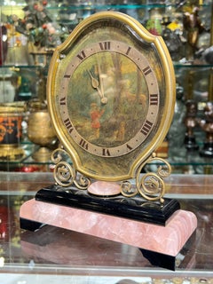 Antiguo reloj suizo de sobremesa de cuarzo rosa y bronce vendido por Cartier