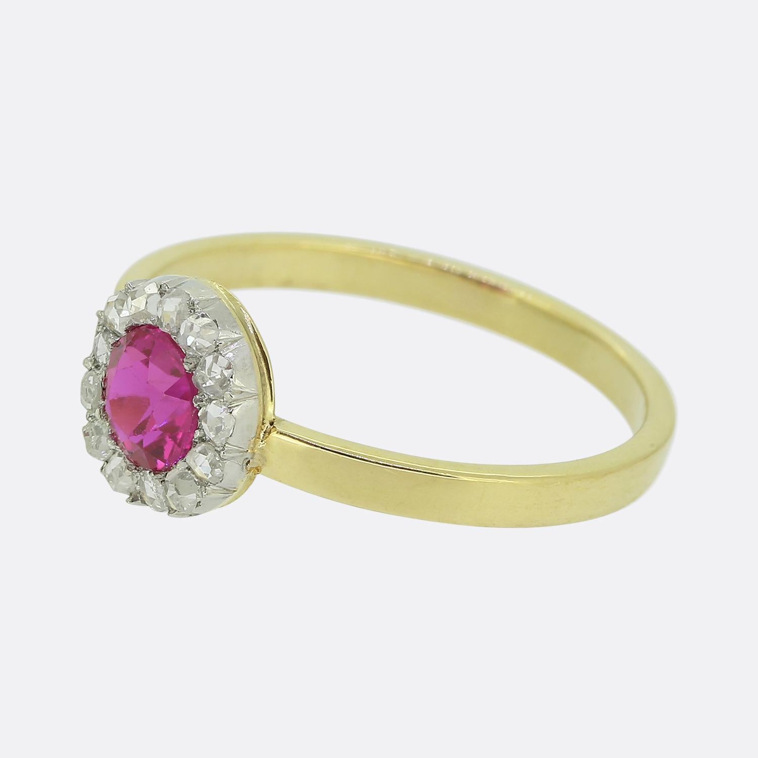Here we have a fabulous ruby and diamond cluster ring originally dating back to the Victorian period. At the centre of the face we find a round faceted bright pinky red synthetic ruby. This principal stone is then circulated by thirteen shimmering