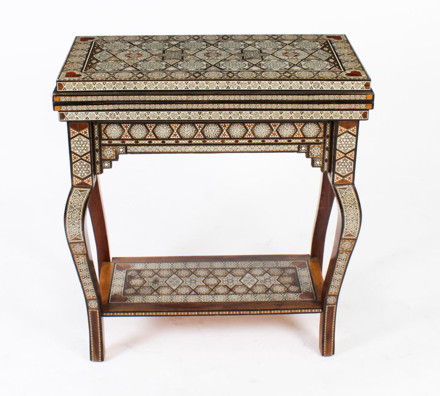 This profusely inlaid Syrian Damascus games table dates from Circa 1910, and has multiple geometric and asymmetric inlays of various exotic veneers.
 
The hinged lid opens to reveal a similarly inlaid interior and a removable reversible top with