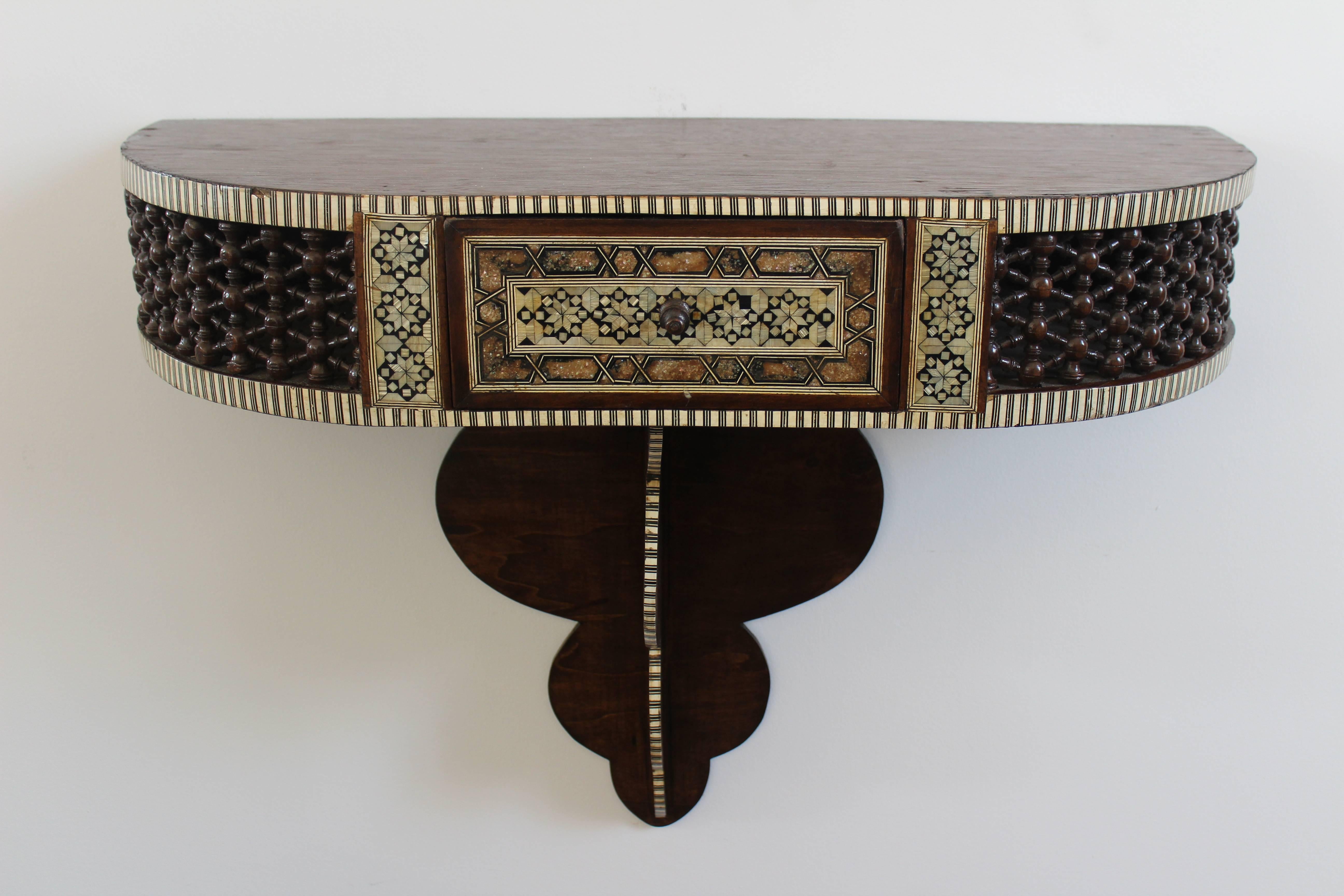 Antique Syrian wall console with a single drawer, perfect for an entry way, hallway or small space. Made of walnut and adorned with inlay mother-of-pearl. This piece has been recently refinished but still retains minor signs of wear. Includes
