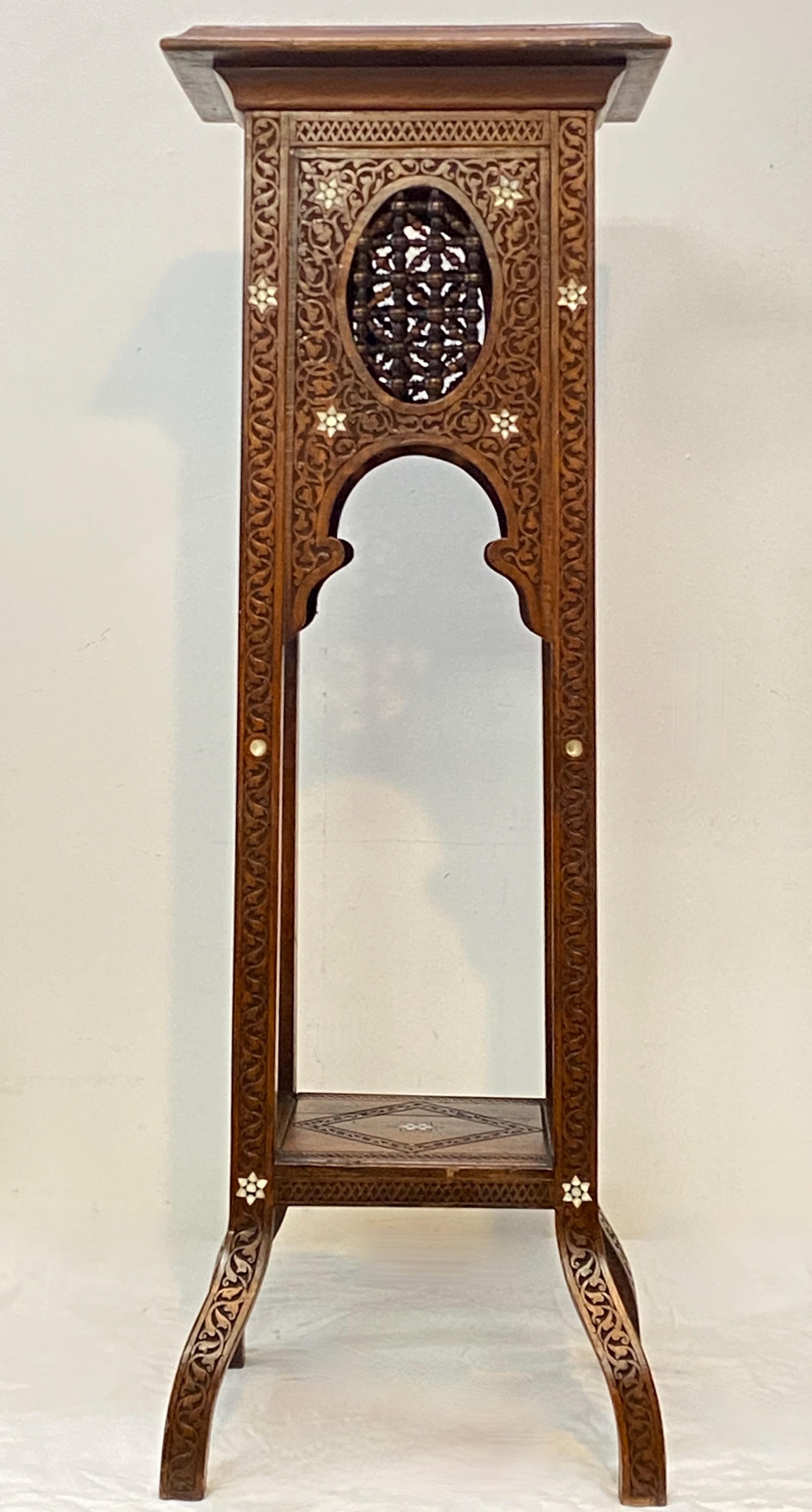 A carved walnut plant stand or pedestal with mother of pearl inlay detail.
Late 19th / early 20th century.
In very good antique condition, having an age crack on the lower shelf.

