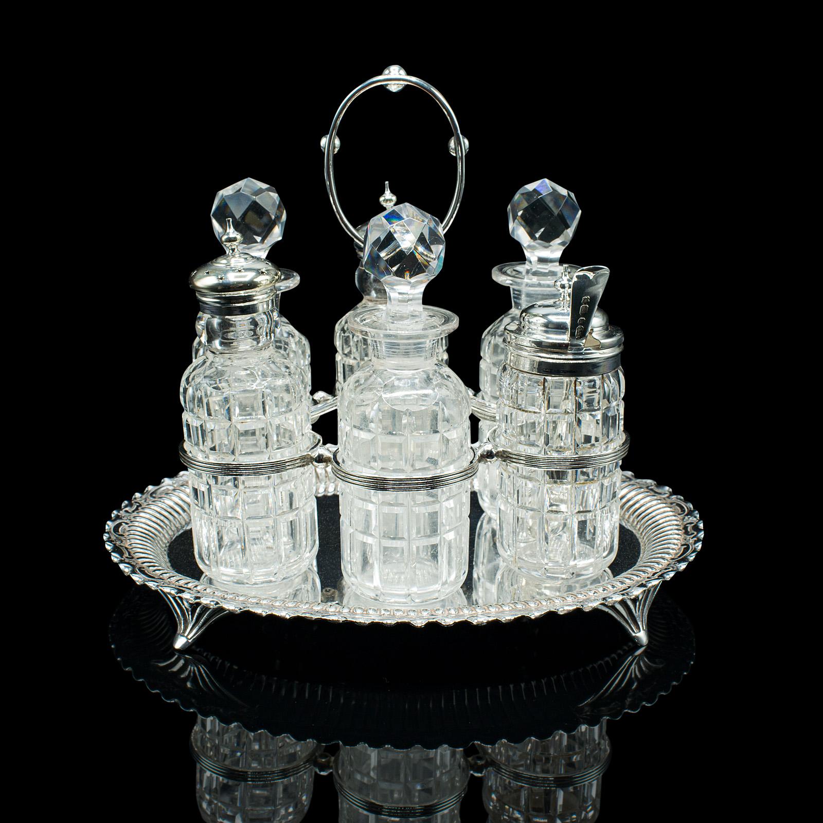 This is an antique table condiment set. An English, silver plate and glass cruet, dating to the Victorian period and later, circa 1900.

Dashing 6 piece table set presented upon an attractive tray
Displaying a desirable aged patina