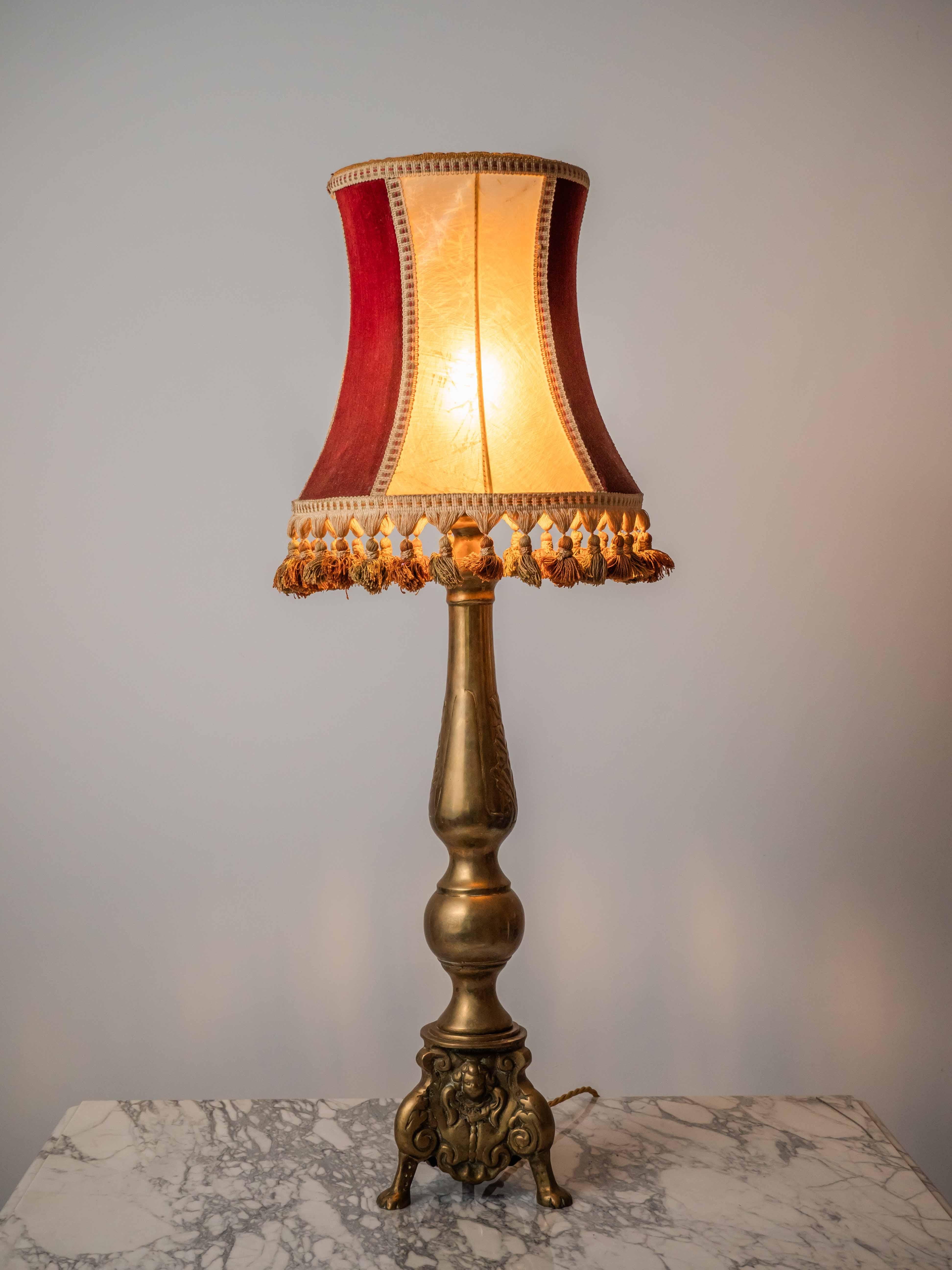 A very heavy leg, originally a baroque candlestick with an original shade made of beef bladder in combination with mohair fabric. The lamp is partially restored: new internal wiring, new old-style grounding cable with gold-colored fabric covering,