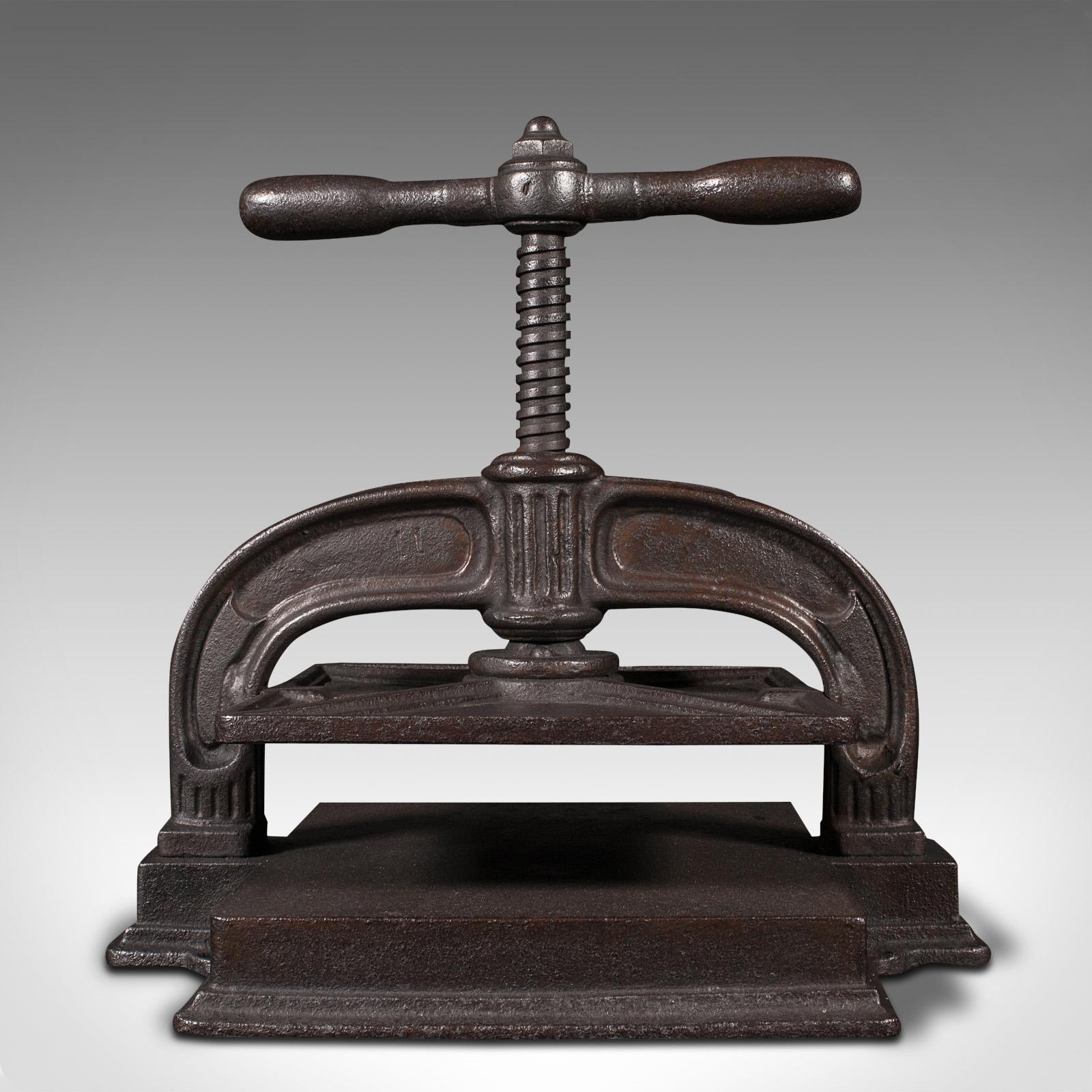 This is an antique tabletop press. An English, cast iron rotary flower pressing machine, dating to the early Victorian period, circa 1850.

Relive the Victorian past-time with this delightful press
Displays a desirable aged patina and in good